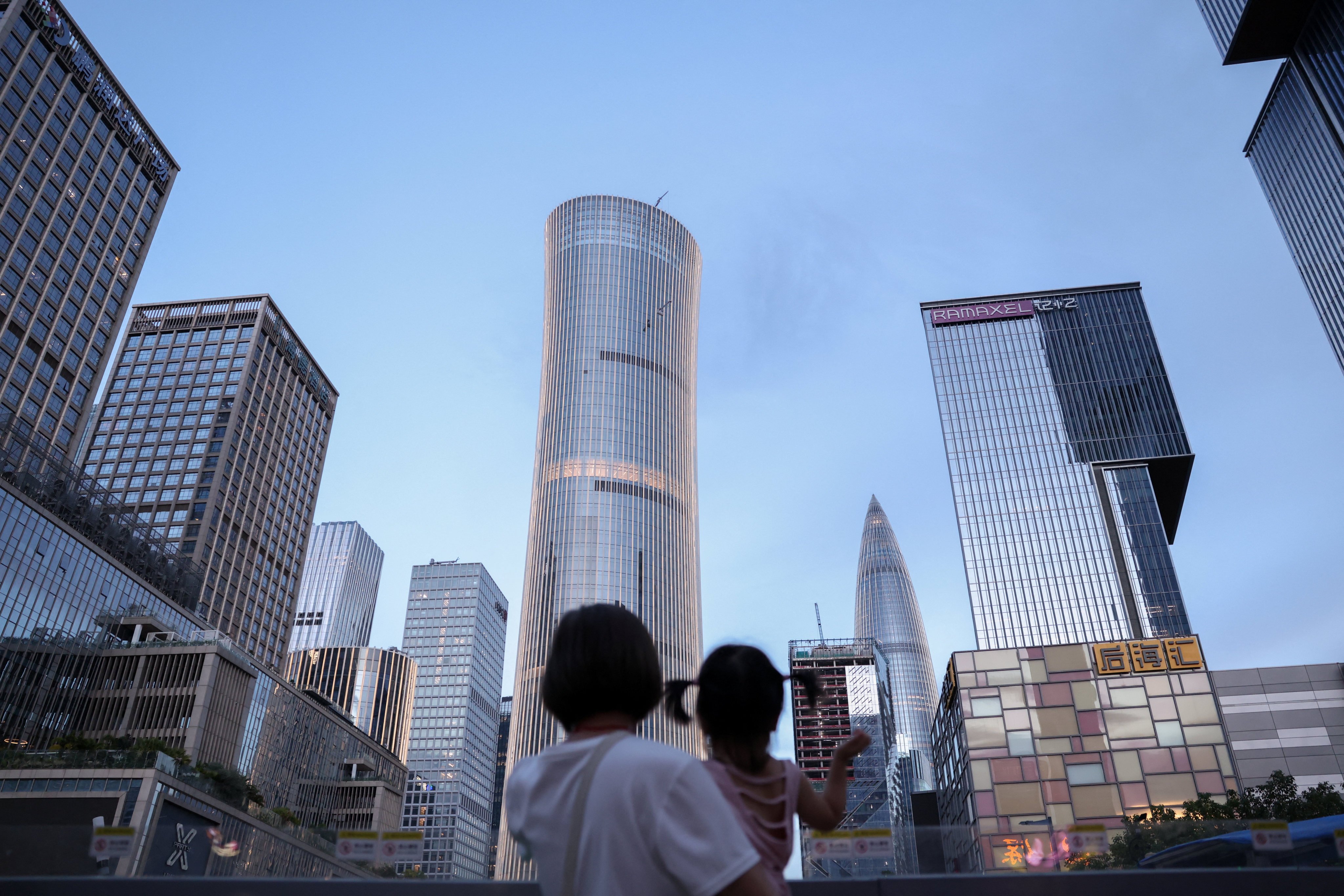A woman holds a child in Shenzhen. Photo: Reuters