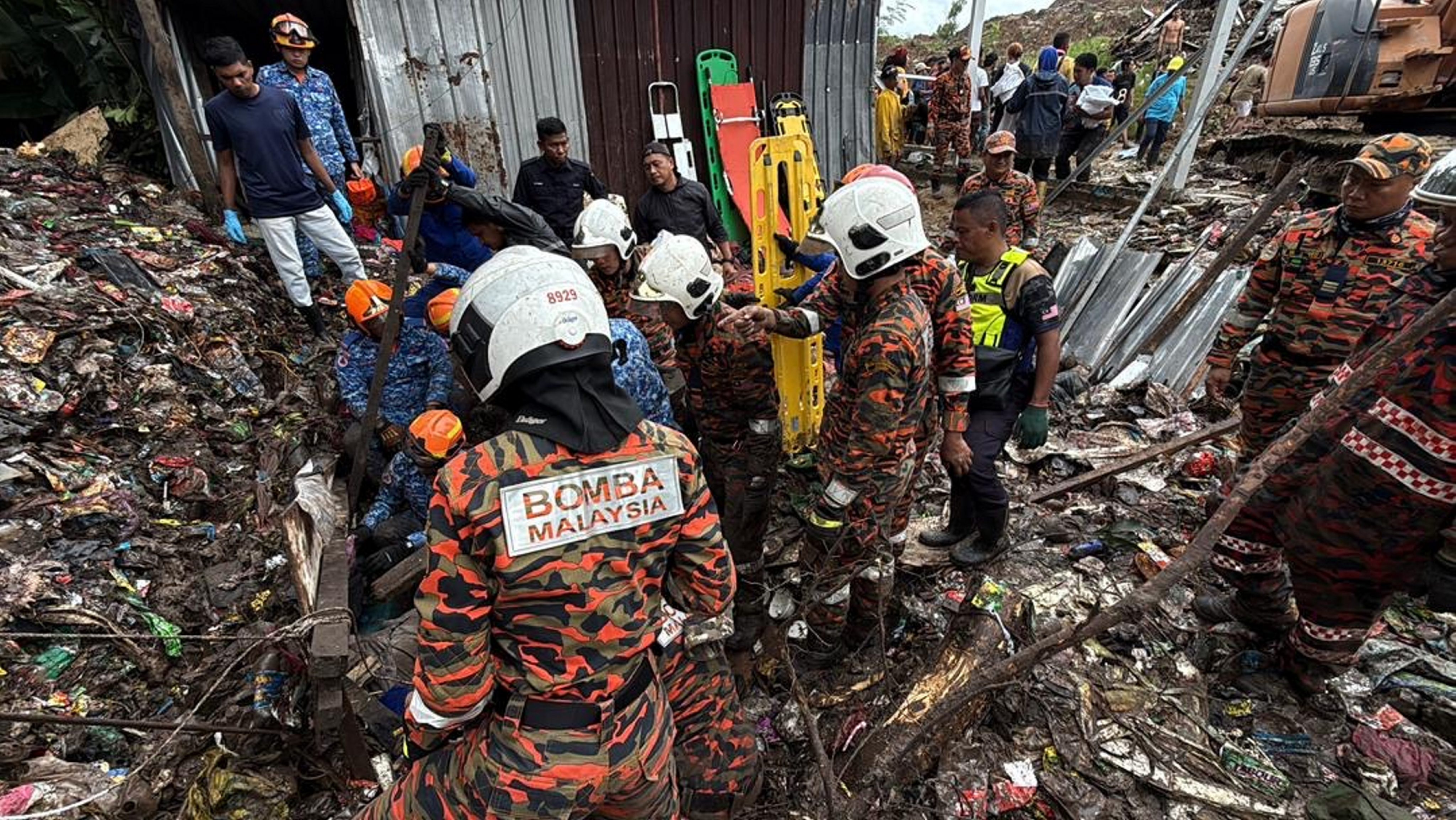 Rescuers work at a village hit by a storm near Kota Kinabalu in Malaysia’s Sabah state on Monday. Photo: Handout via Xinhua