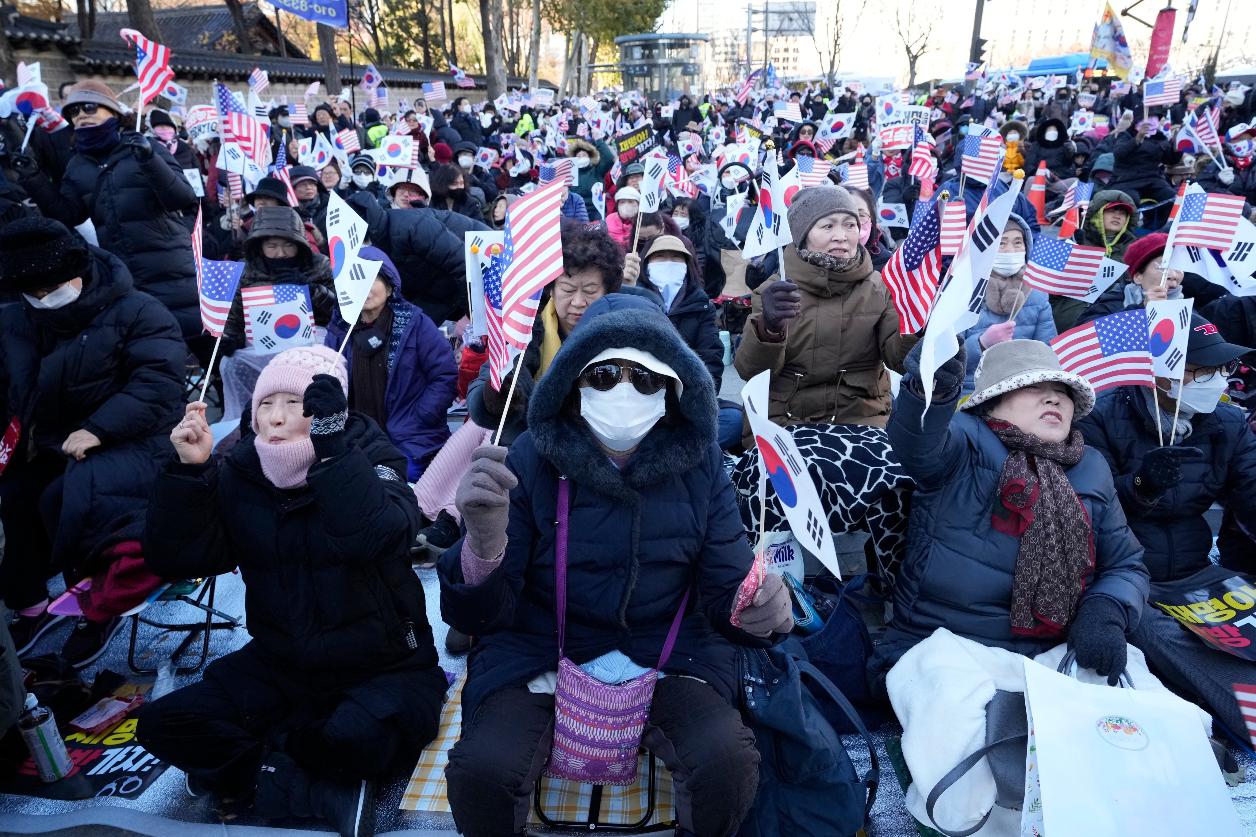 Supporters of then South Korean president Yoon Suk-yeol waving the Korean and US flags stage a rally against opposition politicians in Seoul, South Korea, on December 6 last year. Photo: AP