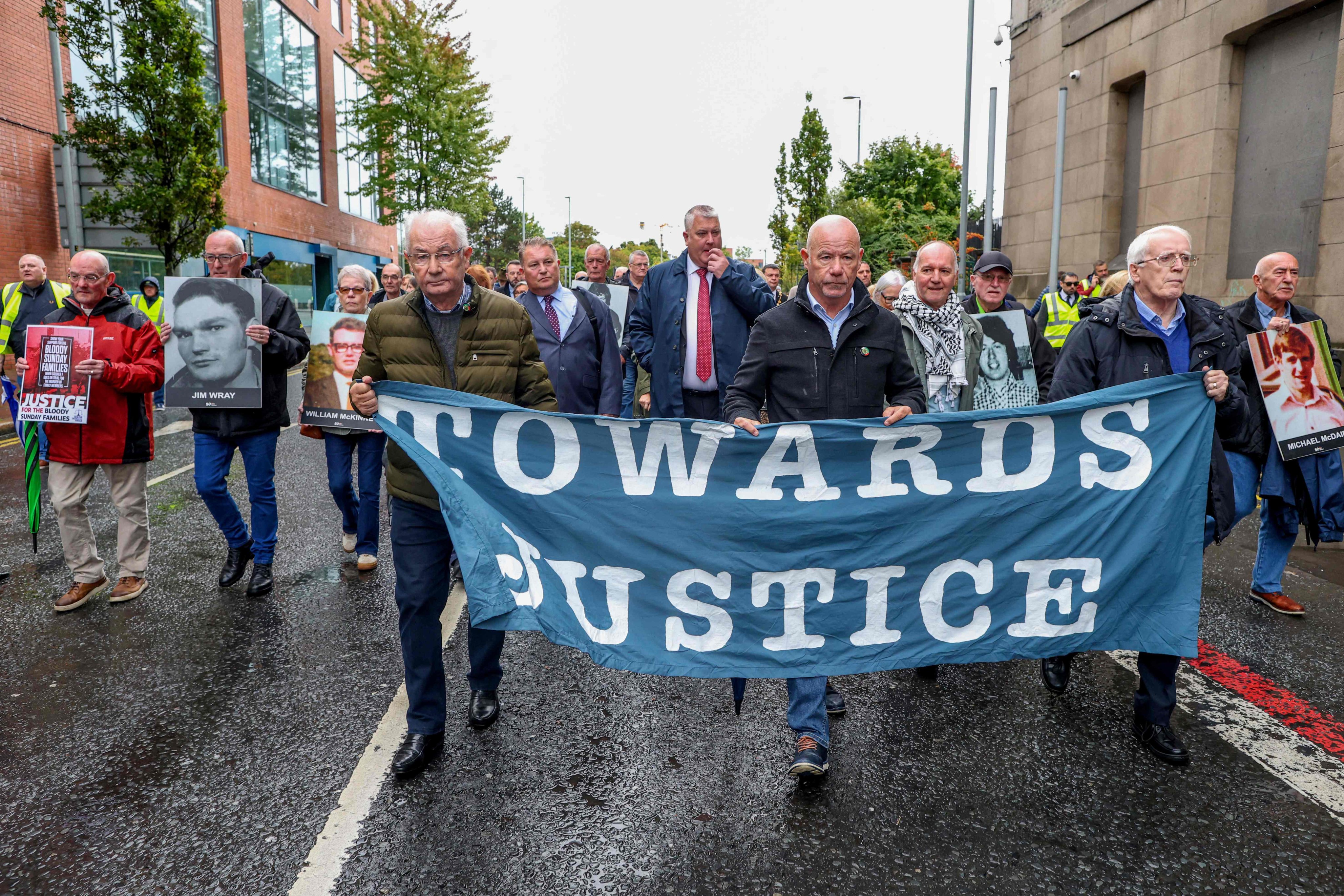 Family members and supporters of those killed on Bloody Sunday walk to Belfast Crown Court as the trial of soldier F begins, in Belfast, Northern Ireland on Monday. Photo: AFP
