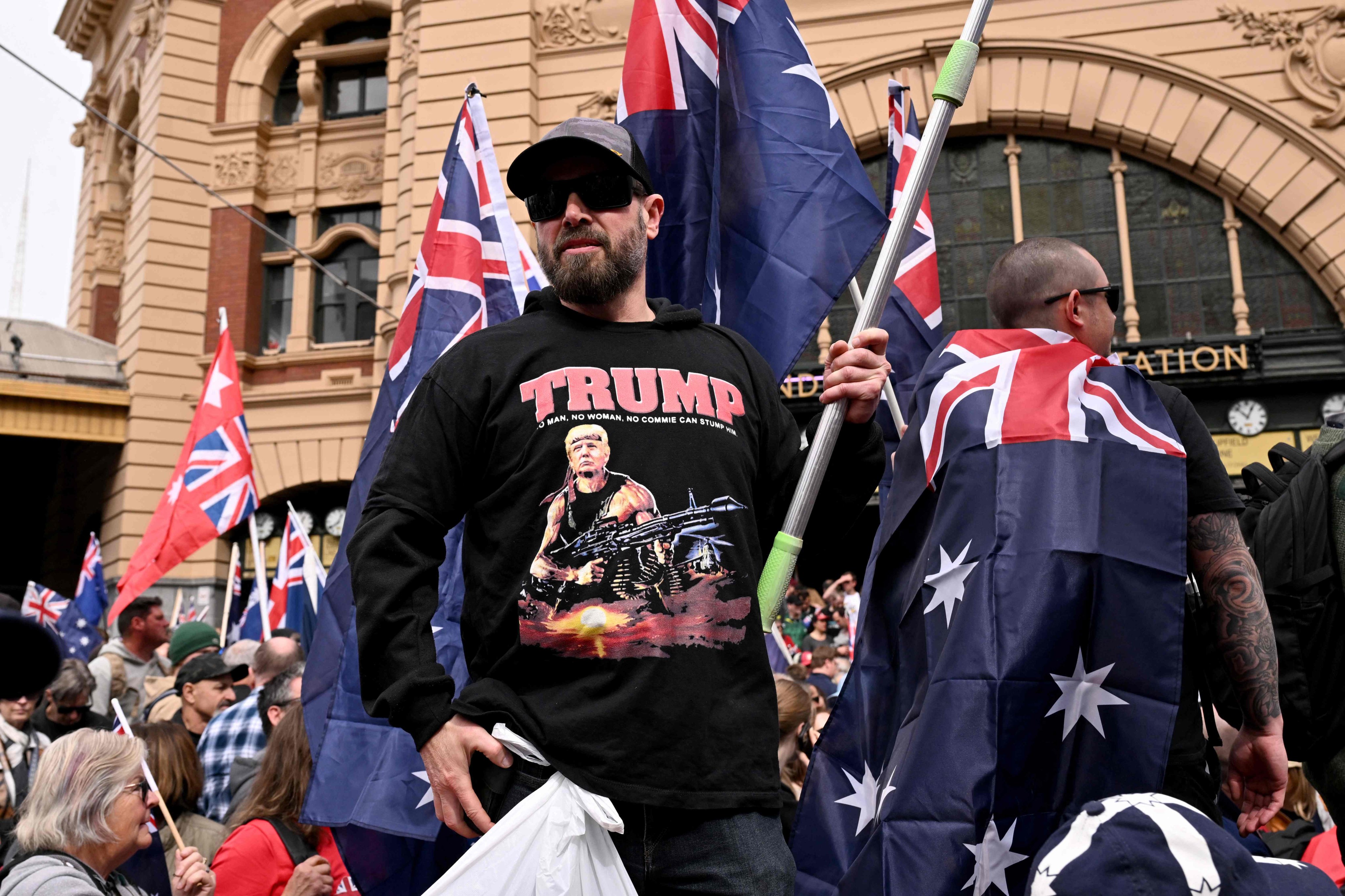 A protester wearing a shirt showing an image of US President Donald Trump as a stylised depiction of Rambo takes part in a March for Australia anti-immigration rally in Melbourne on August 31. Photo: AFP