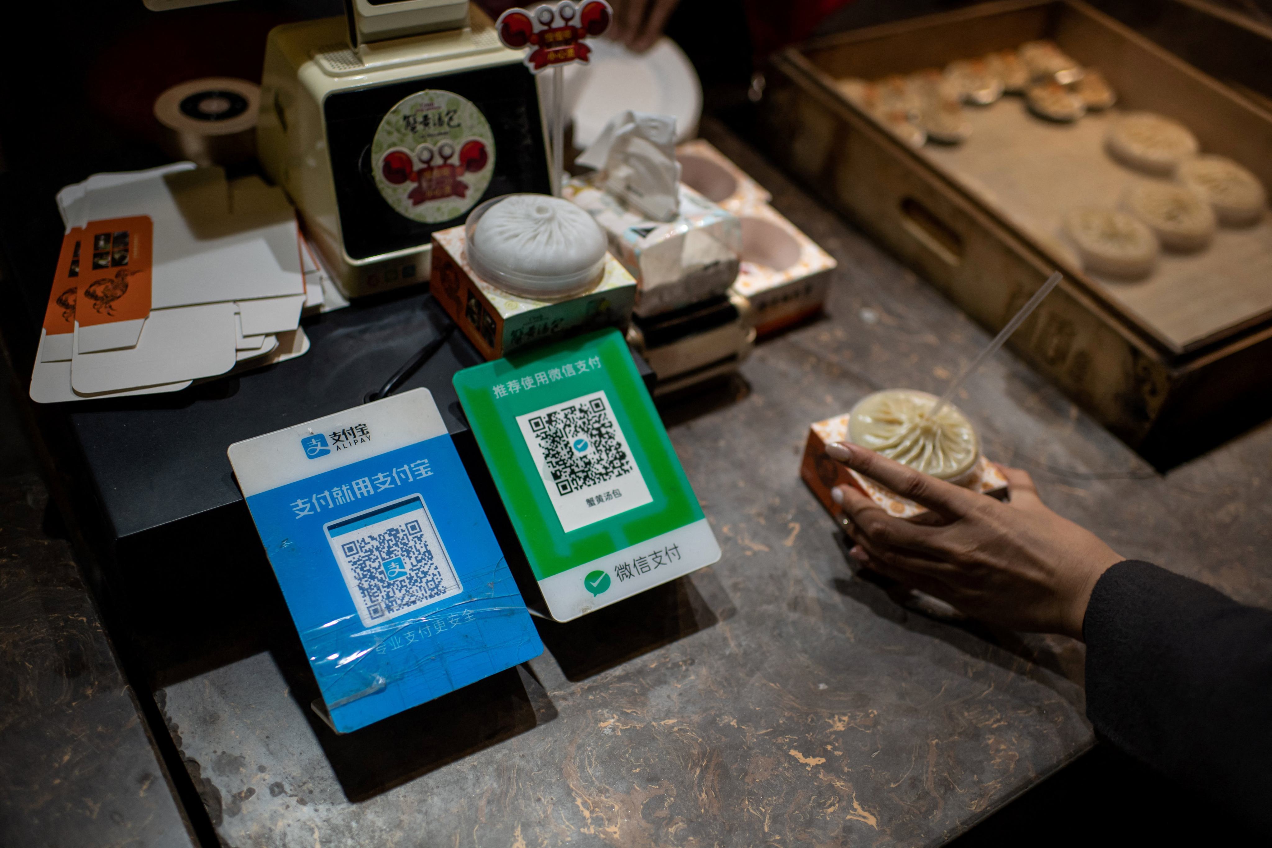 An Alipay QR code (left) and a Weixin Pay QR code displayed at a shop in Beijing. Photo: AFP