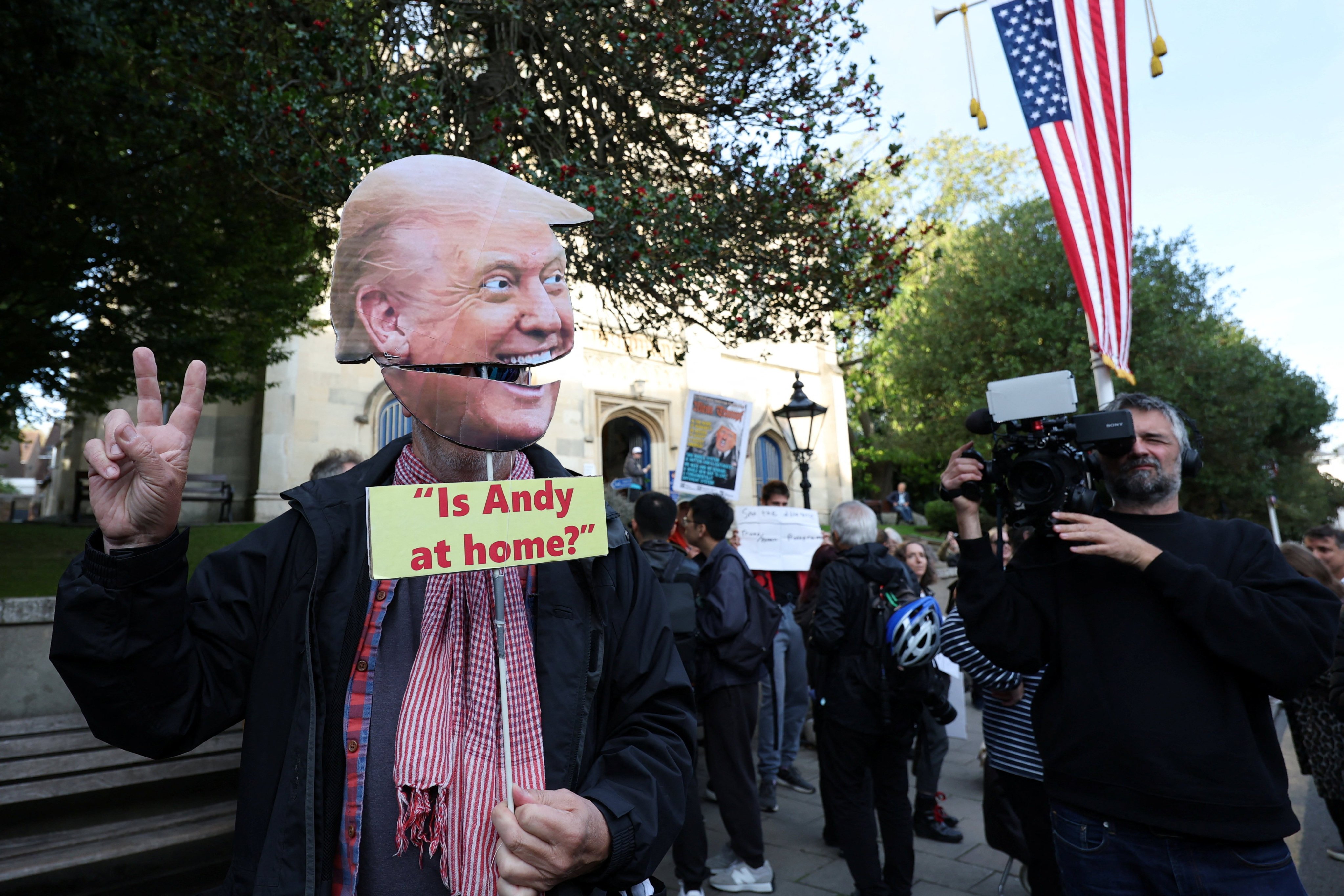 A demonstrator wears a cardboard cutout depicting US President Donald Trump’s face in Windsor, Britain, on Tuesday. Photo: Reuters