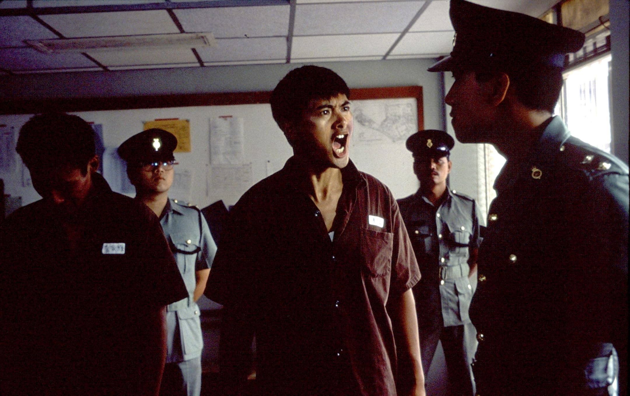 Chow Yun-fat (centre) and Roy Cheung Yiu-yeung (right) in a still from Prison on Fire (1987)