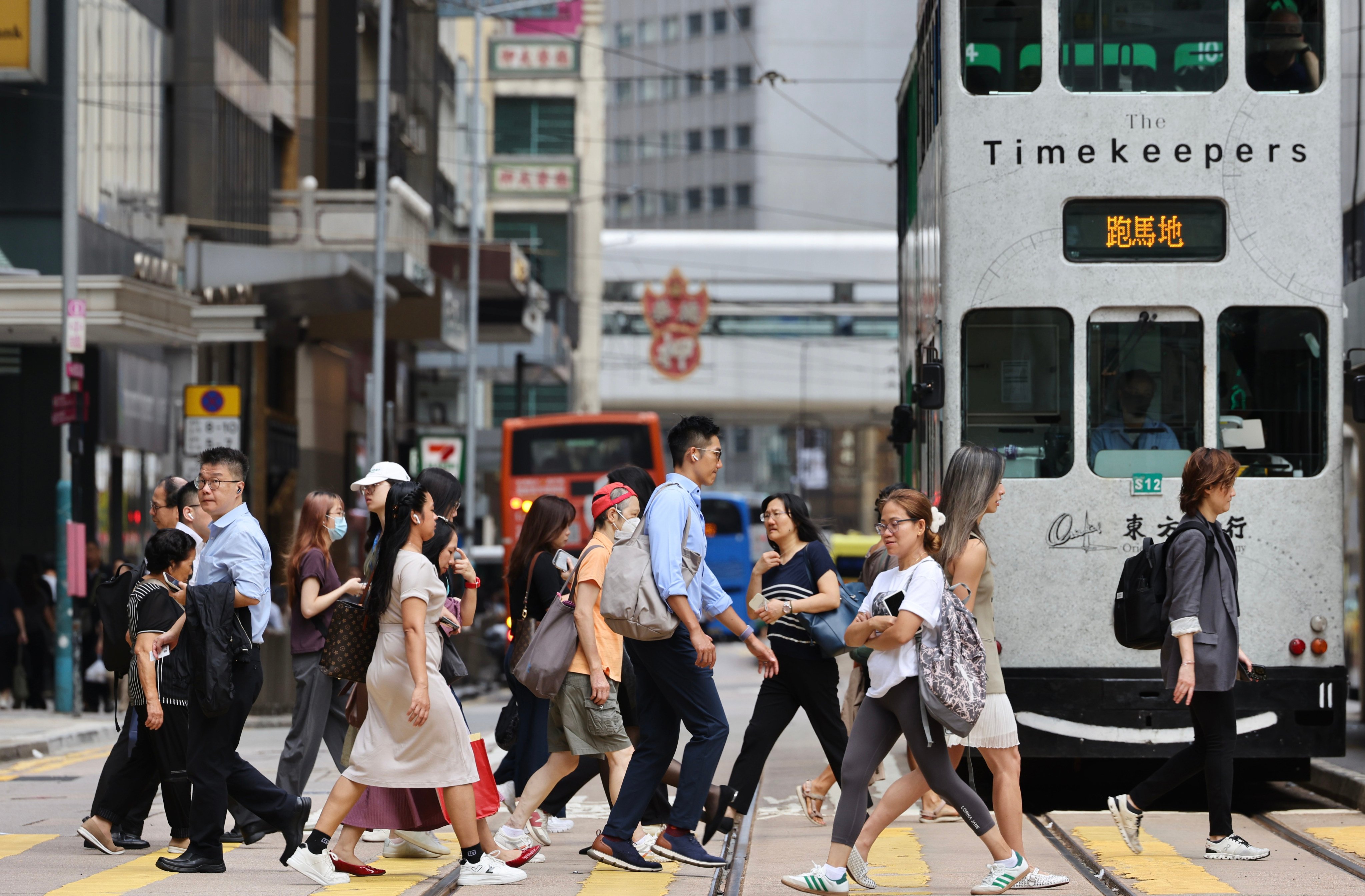 People cross the street in the city’s central business district. Photo: Karma Lo