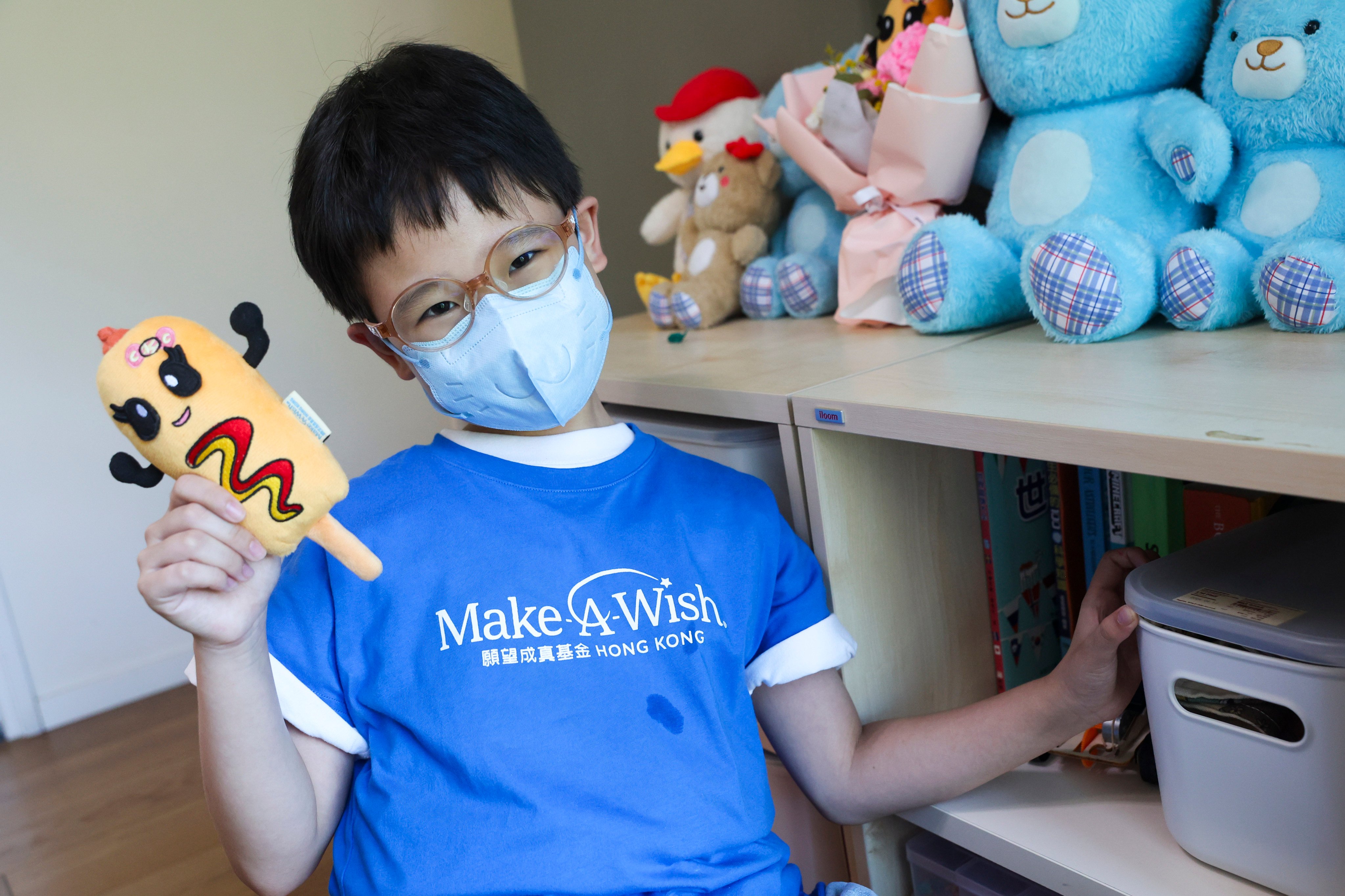 Sophie Chan, nine, holds a Corny Ketchy, a plush toy she designed with the help of children’s charity Make-A-Wish Hong Kong, and is distributing to inspire children to “never give up”. Photo: Edmond So