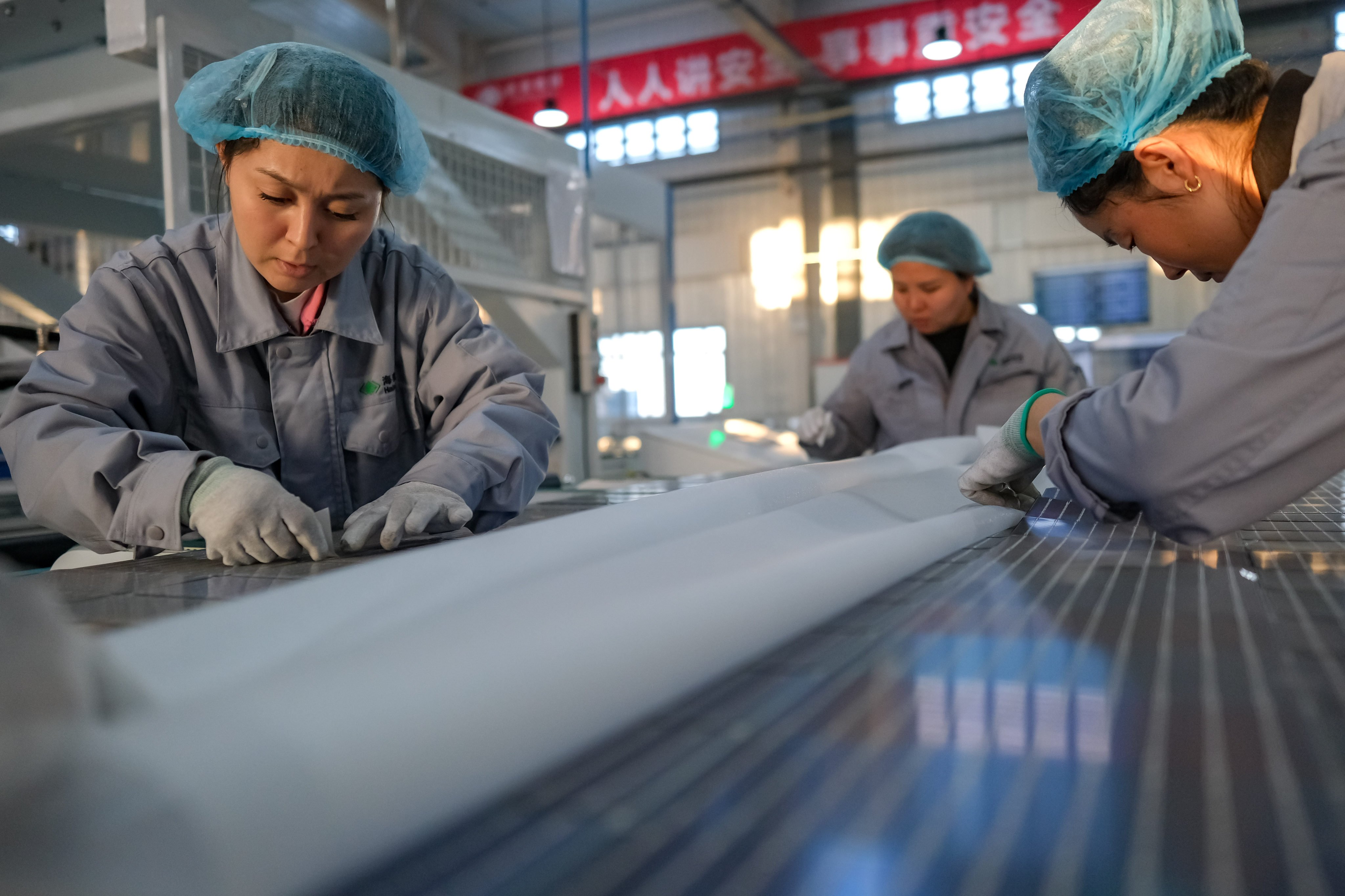 Workers produce components for photovoltaic solar panels at a factory in China’s northwestern Xinjiang Uygur autonomous region. Exports from the region to the United States are surging despite Washington’s 2022 trade restrictions targeting the region. Photo: Xinhua
