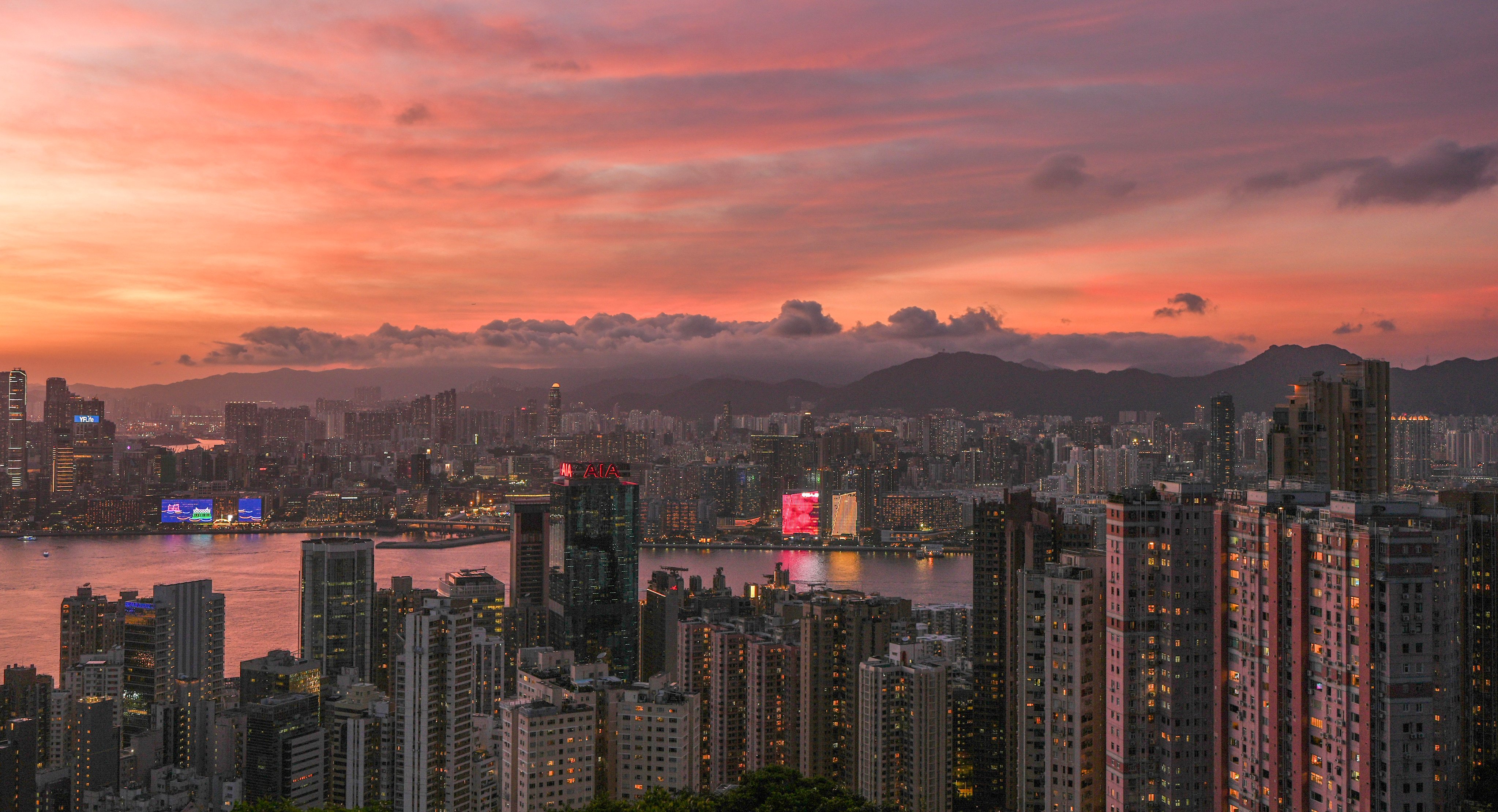 Hong Kong is lit up at sunset on July 23, 2024. Photo: Eugene Lee