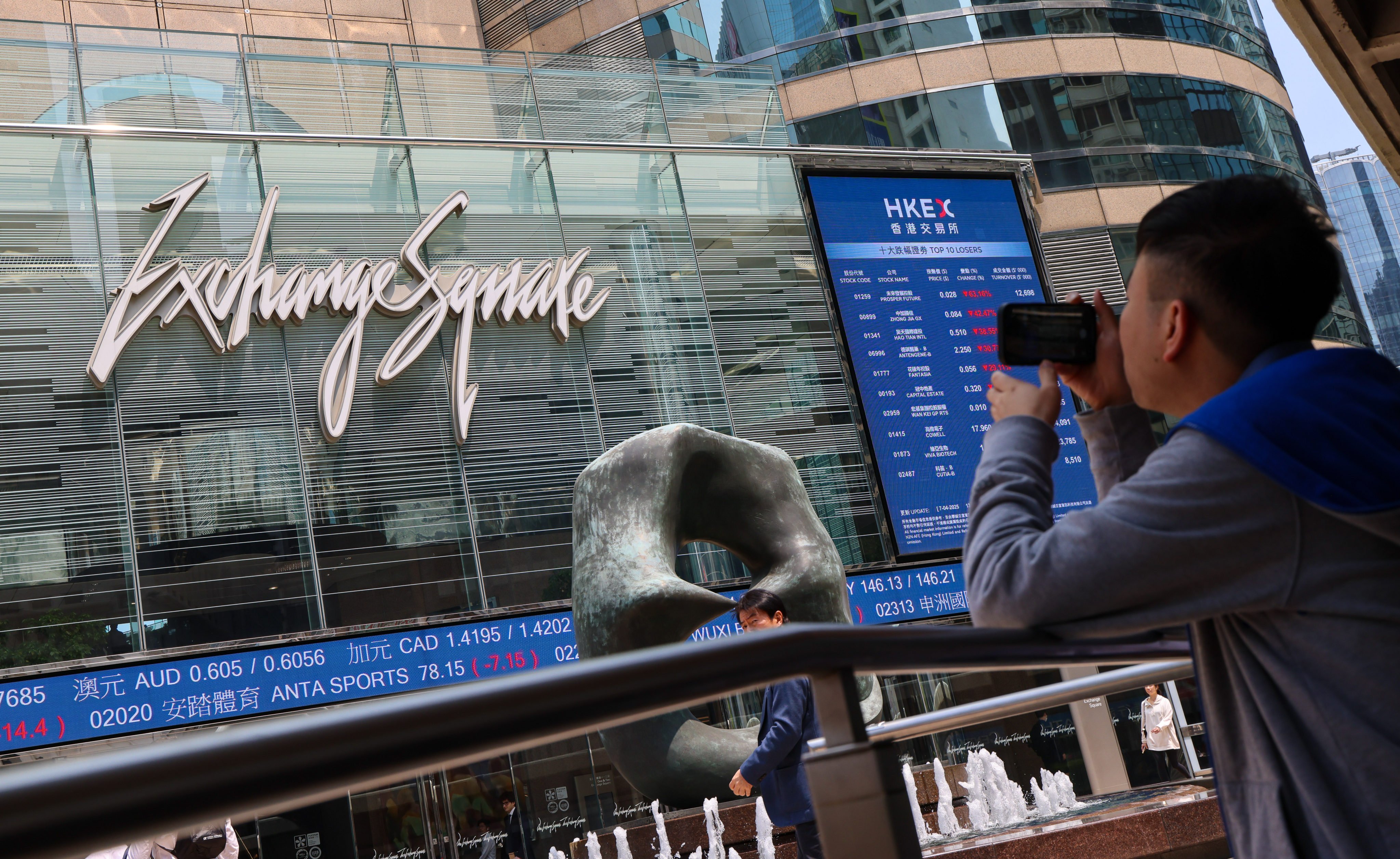 A man photographs Exchange Square in Central, where Hong Kong’s bourse operator is based, on April 7, 2025. Photo: Jelly Tse