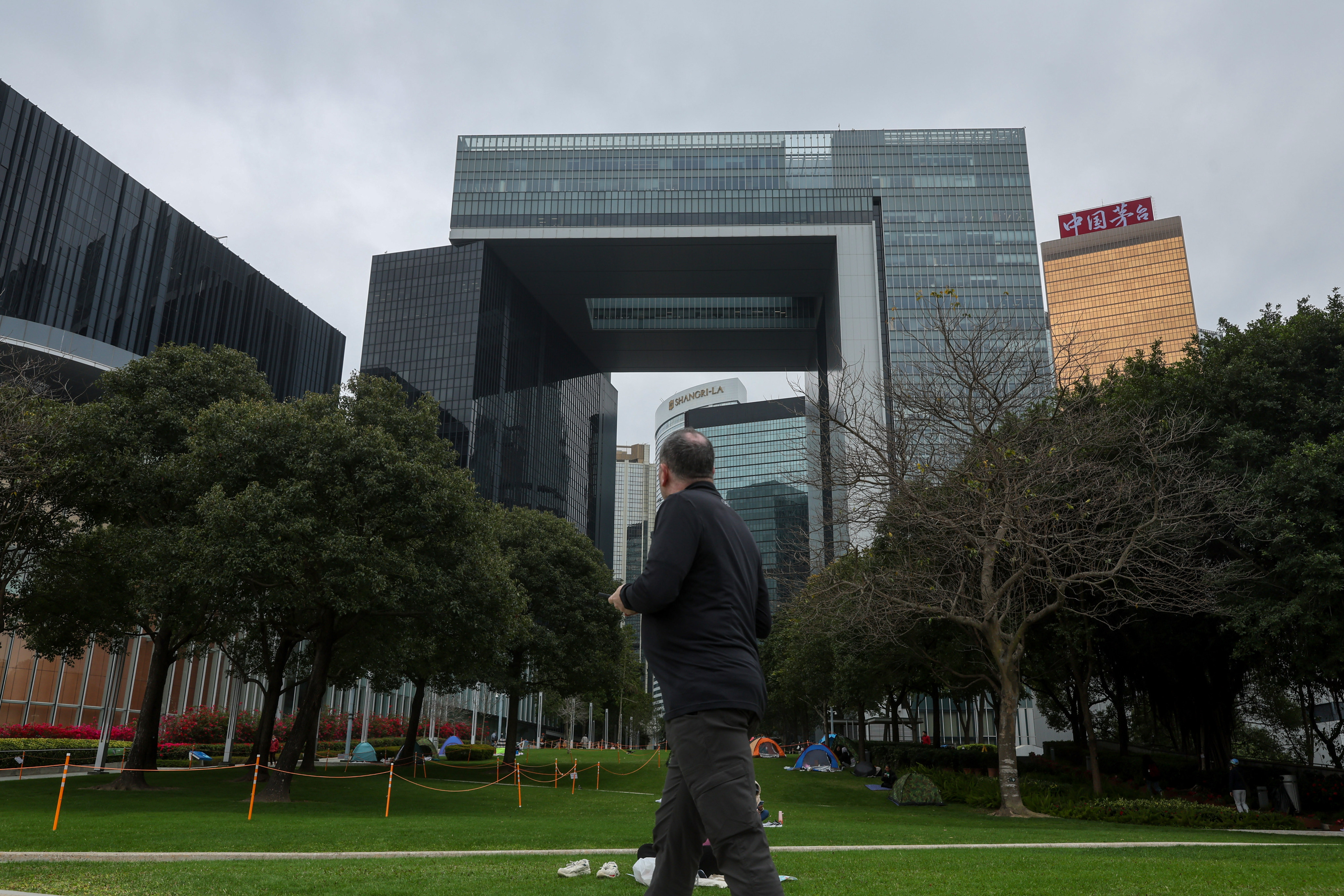 A man looks at the government’s headquarters in Tamar, Admiralty, on February 22, 2025. Photo: Edmond So