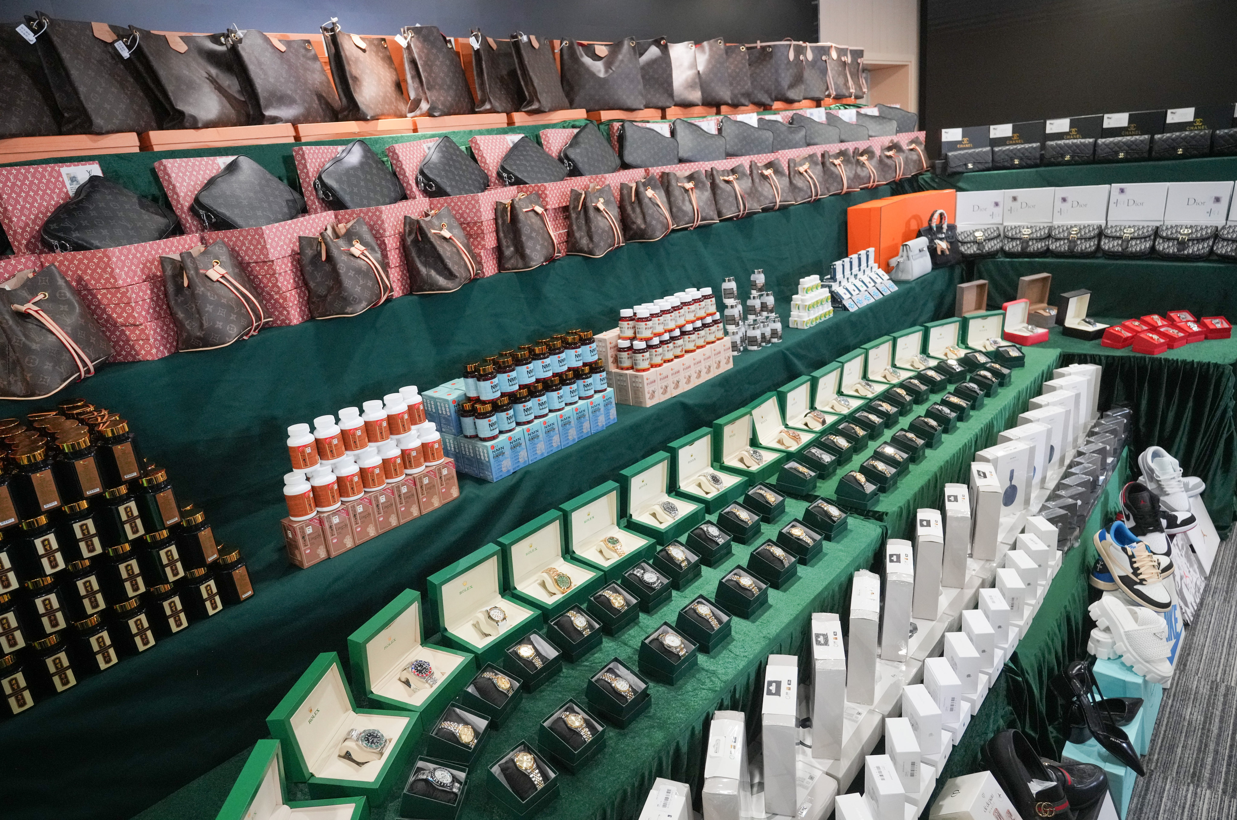 The seized items include counterfeit designer handbags and watches. Photo: May Tse