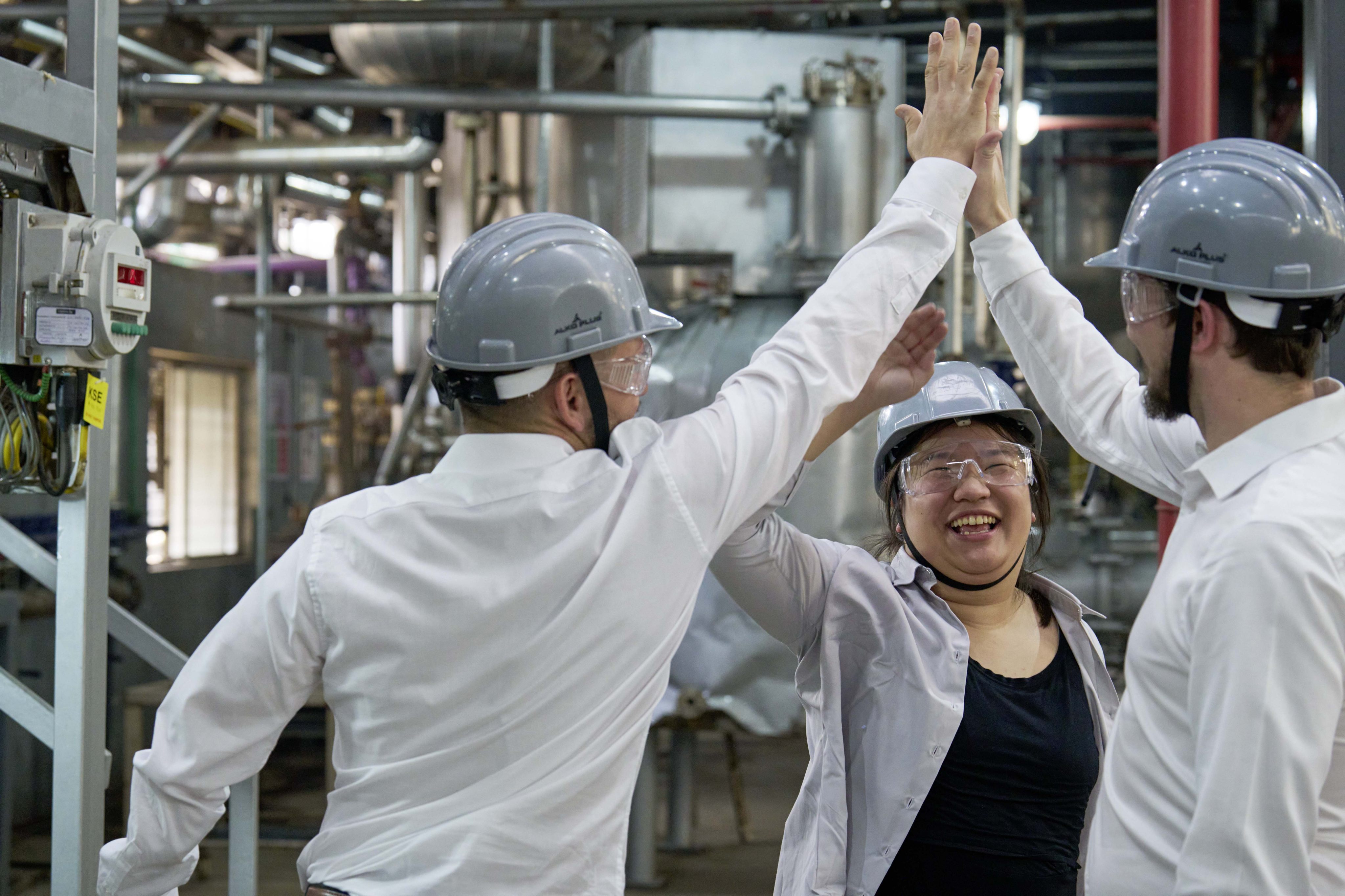 Miranda Wang (centre), co-founder of Novoloop, celebrates a success with members of her team at its demonstration pilot plant in Surat, India, which began continuous operations in April last year. Photo: Rolex/Greg White