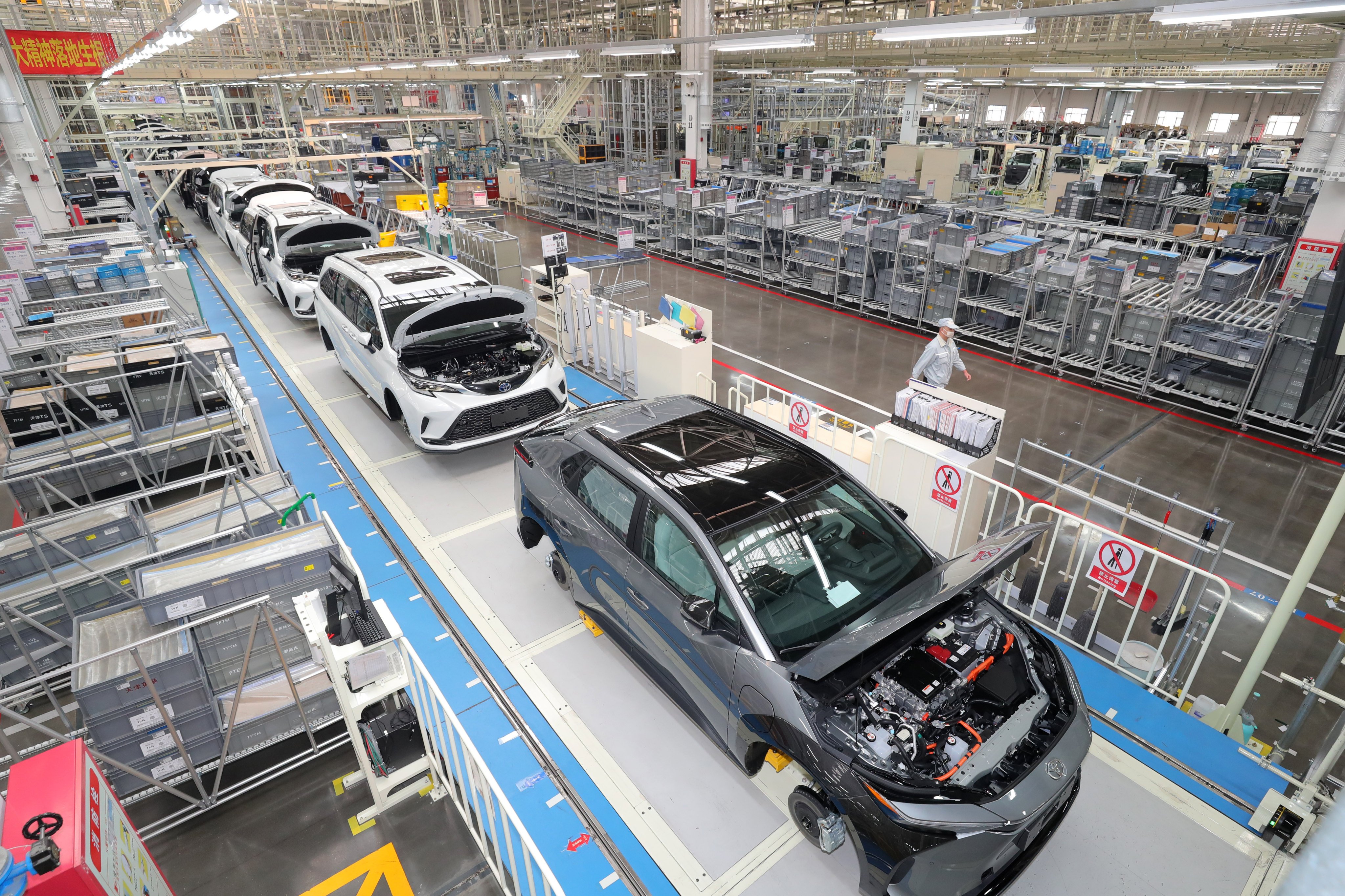 Employees work on the production line of new energy vehicles at a new energy vehicle (NEV) plant of FAW Toyota in Tianjin, China. Photo: VCG/VCG via Getty Images