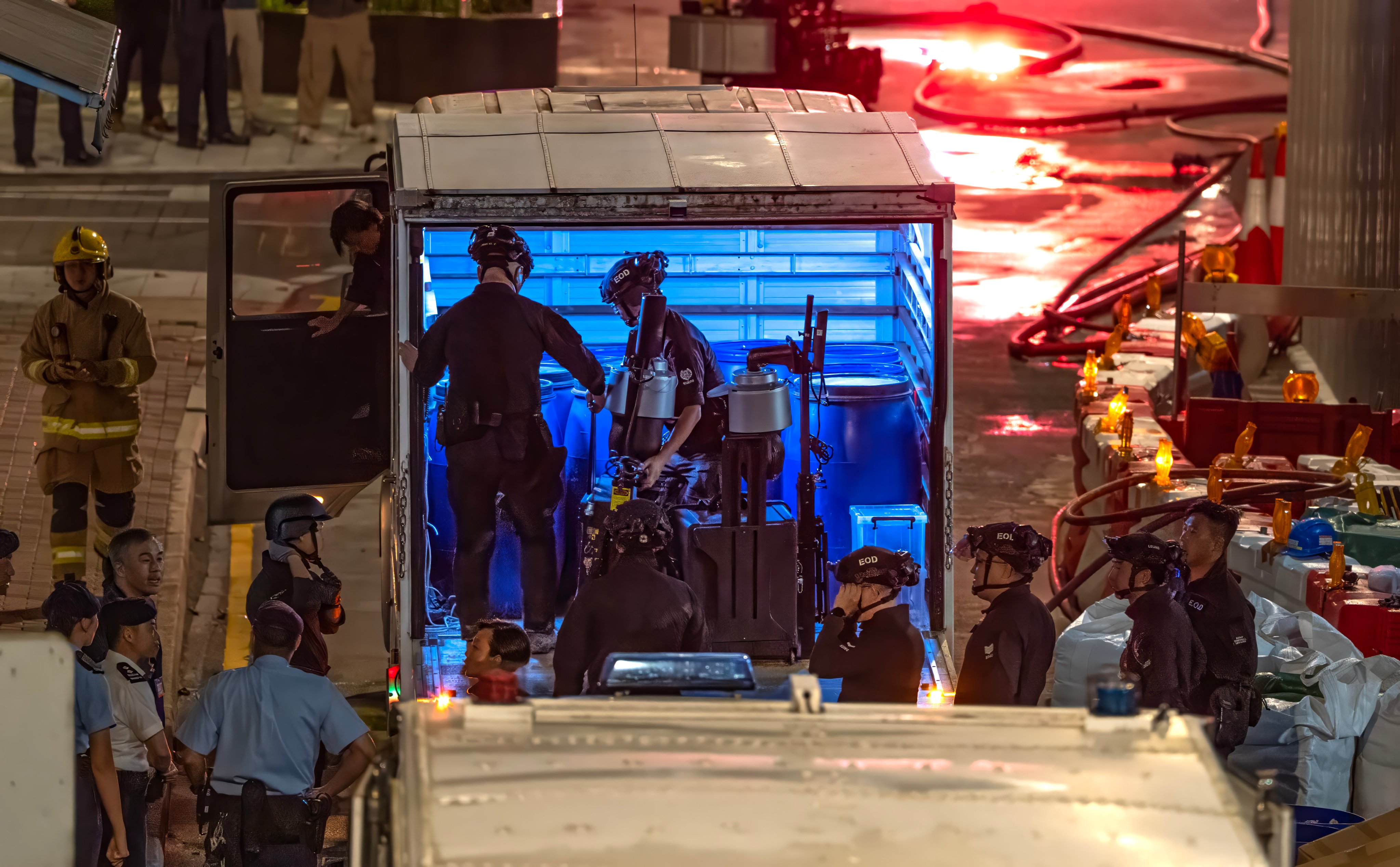 Officers from the bomb disposal team get their gear ready on Pan Hoi Street. Photo: Robert Ng