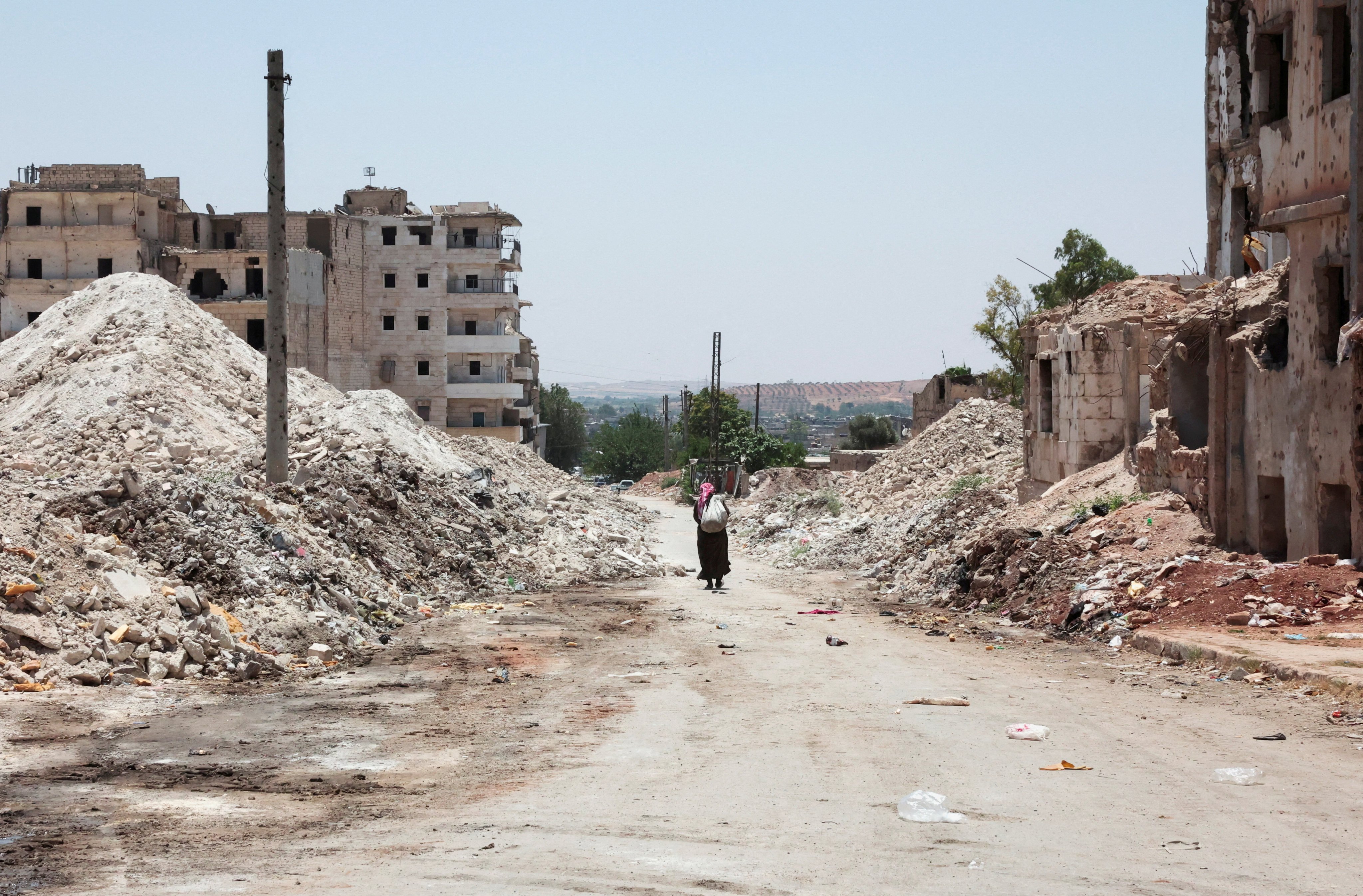A man walks among the destruction in the city of Aleppo, Syria, on June 23. Photo: Reuters