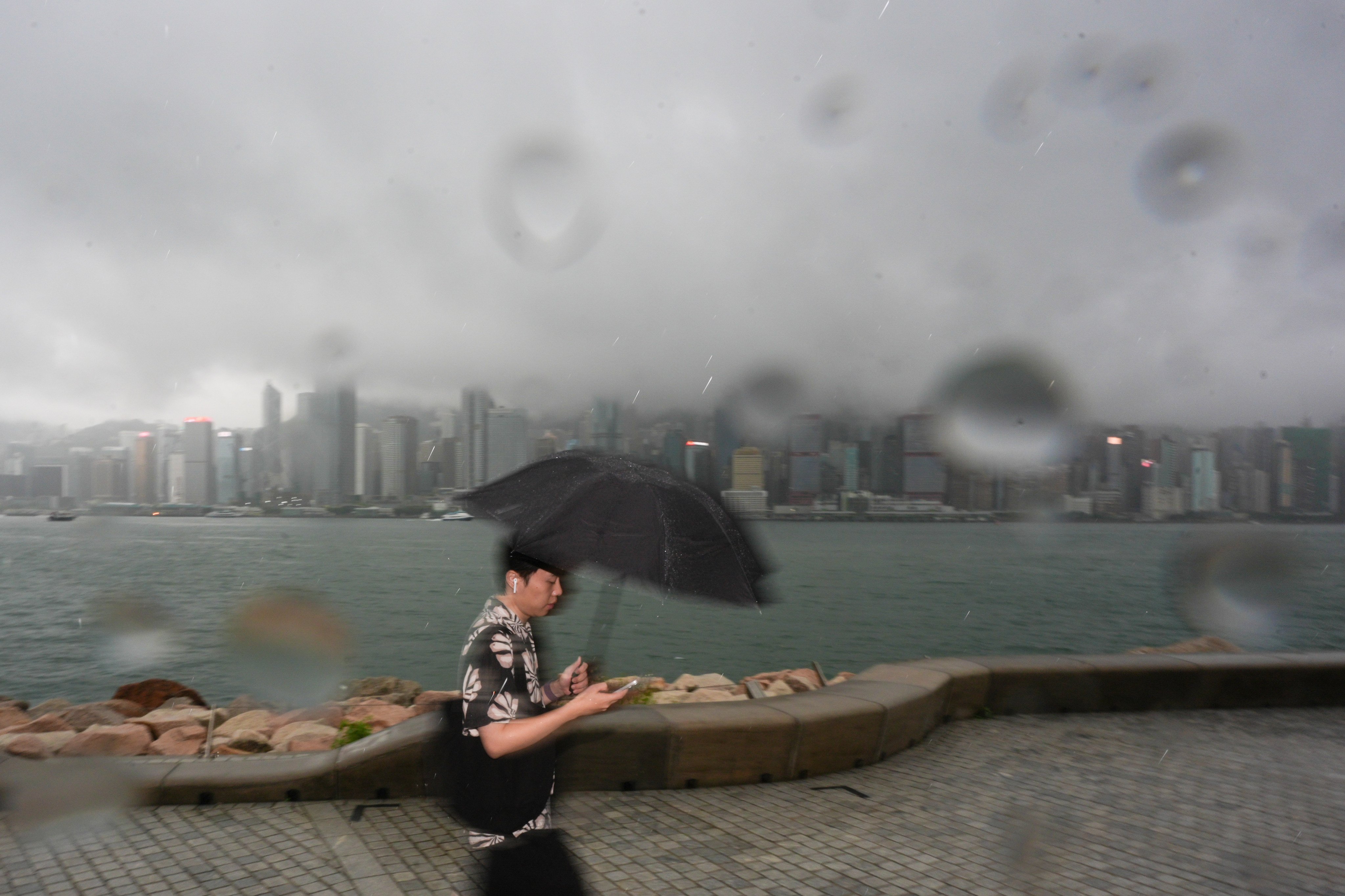 A man walks through the West Kowloon Cultural District in the rain on Saturday. Photo: Eugene Lee