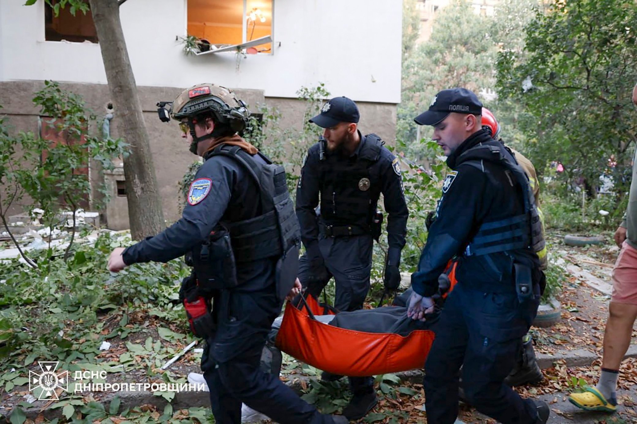 Ukrainian rescuers work at the site of a drone strike near a residential building in Dnipro, Ukraine, on Sunday. Photo: State Emergency Service/EPA