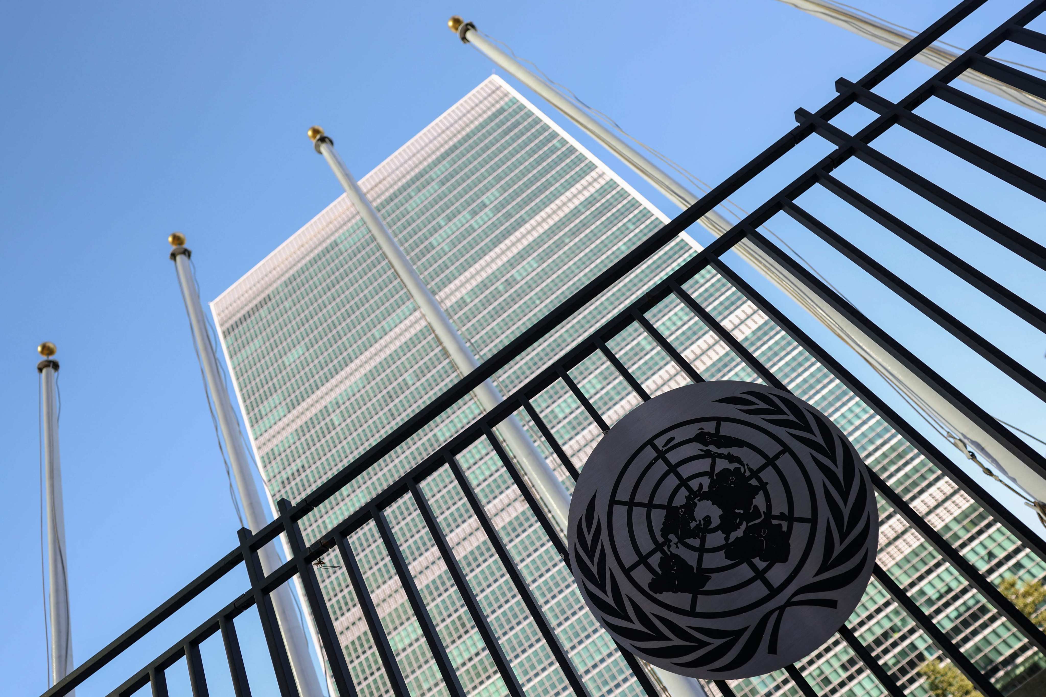 The United Nations logo is seen on a fence outside UN Headquarters in New York City. Photo: AFP