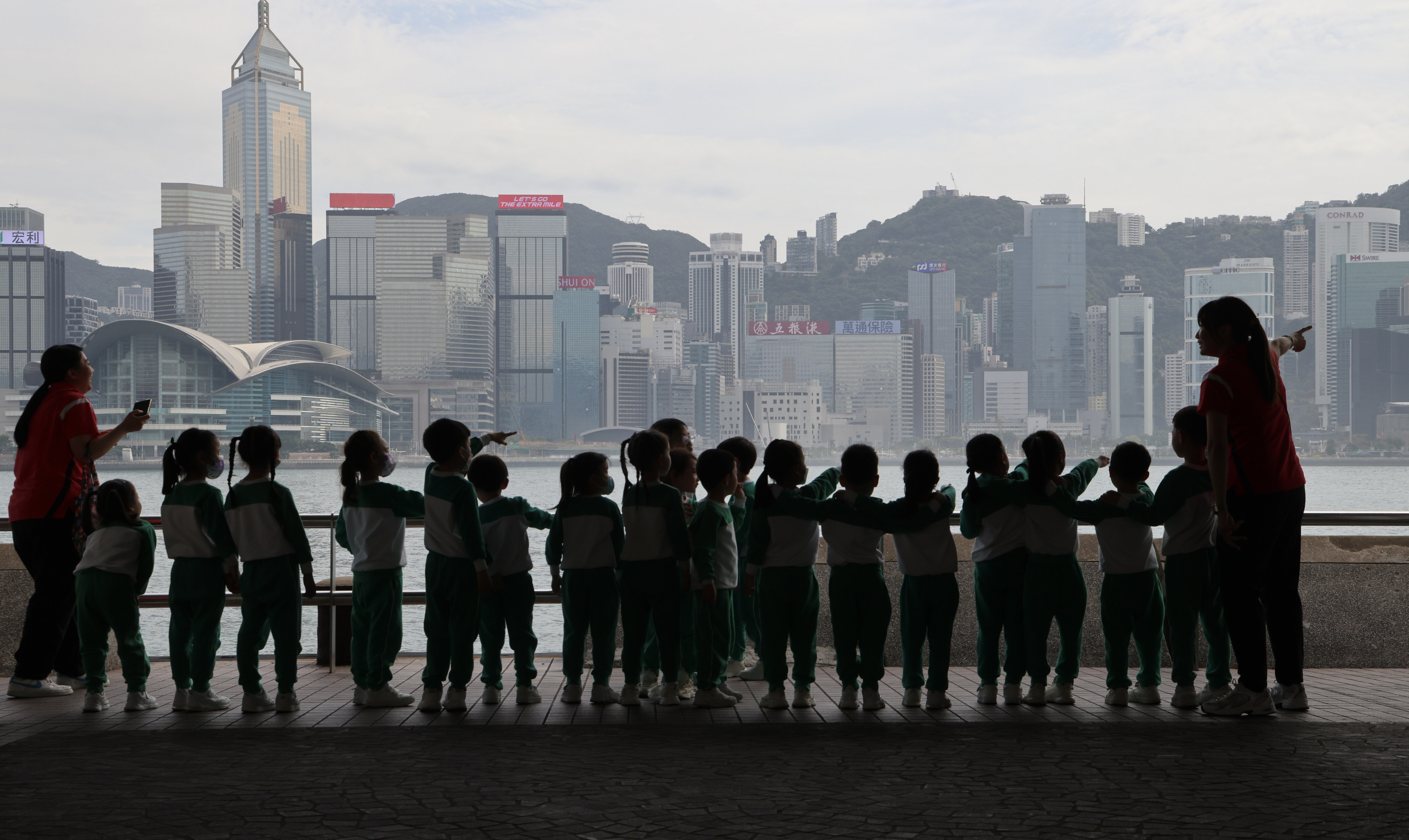 A group of kindergarten students look out over Victoria Harbour at Tsim Sha Tsui on March 13. Photo: Jelly Tse
