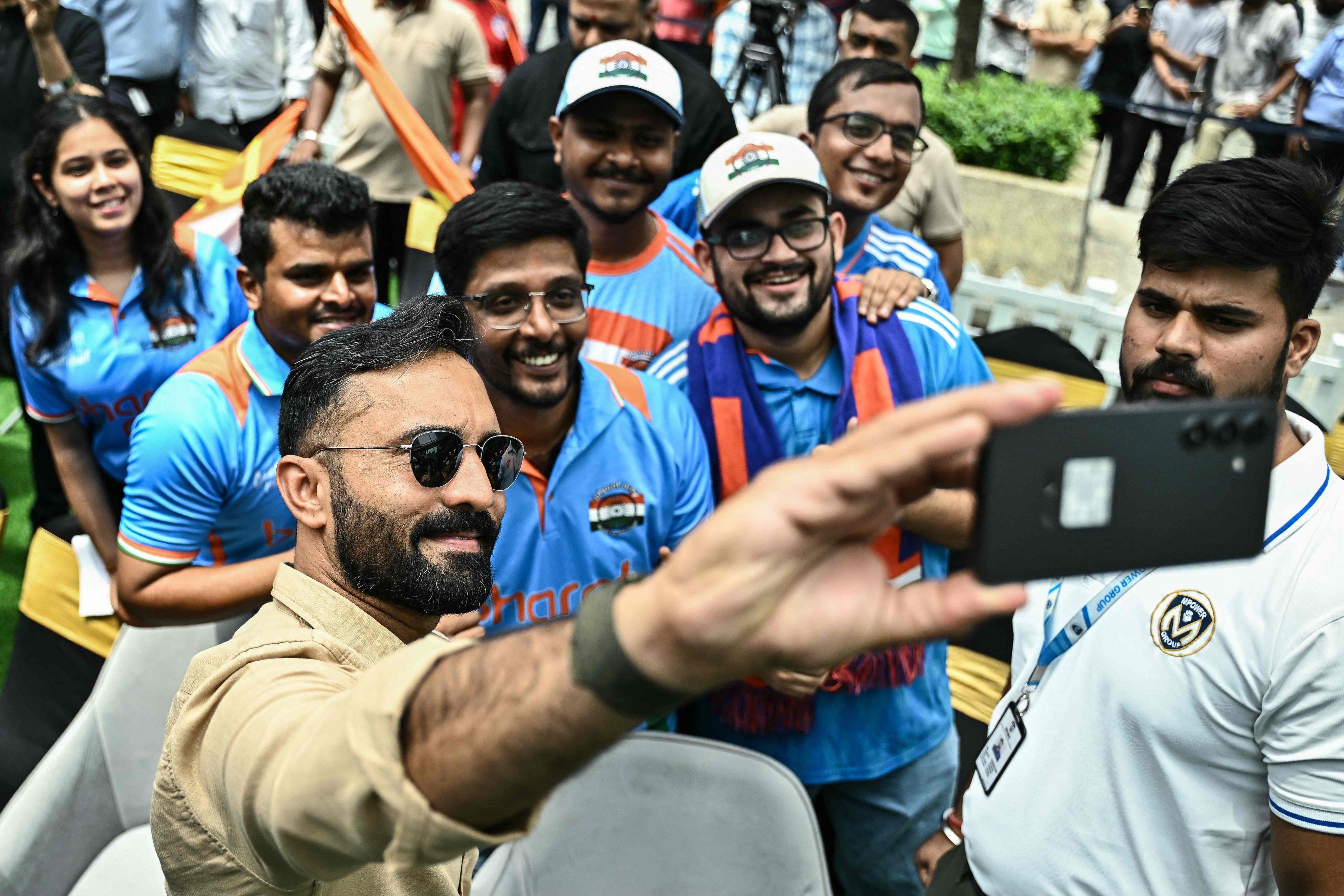 Dinesh Karthik takes a selfie with cricket fans during the unveiling of the ICC Women’s Cricket World Cup Trophy in Bengaluru on September 13, 2025. Photo: AFP