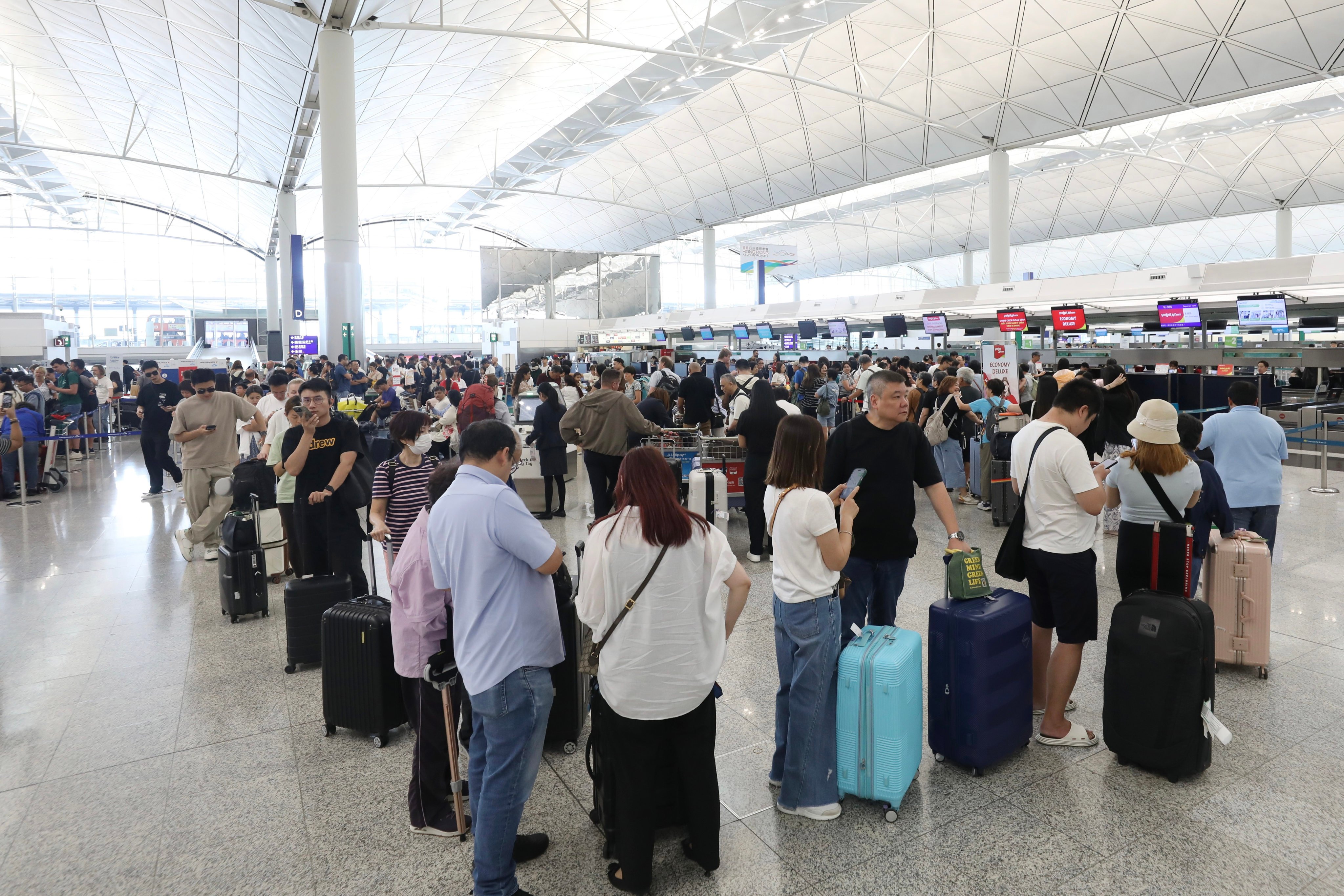 Passengers in the departure hall of Hong Kong International Airport on Tuesday. Many flights have been cancelled due to the approaching Super Typhoon Ragasa. Photo: Sun Yeung