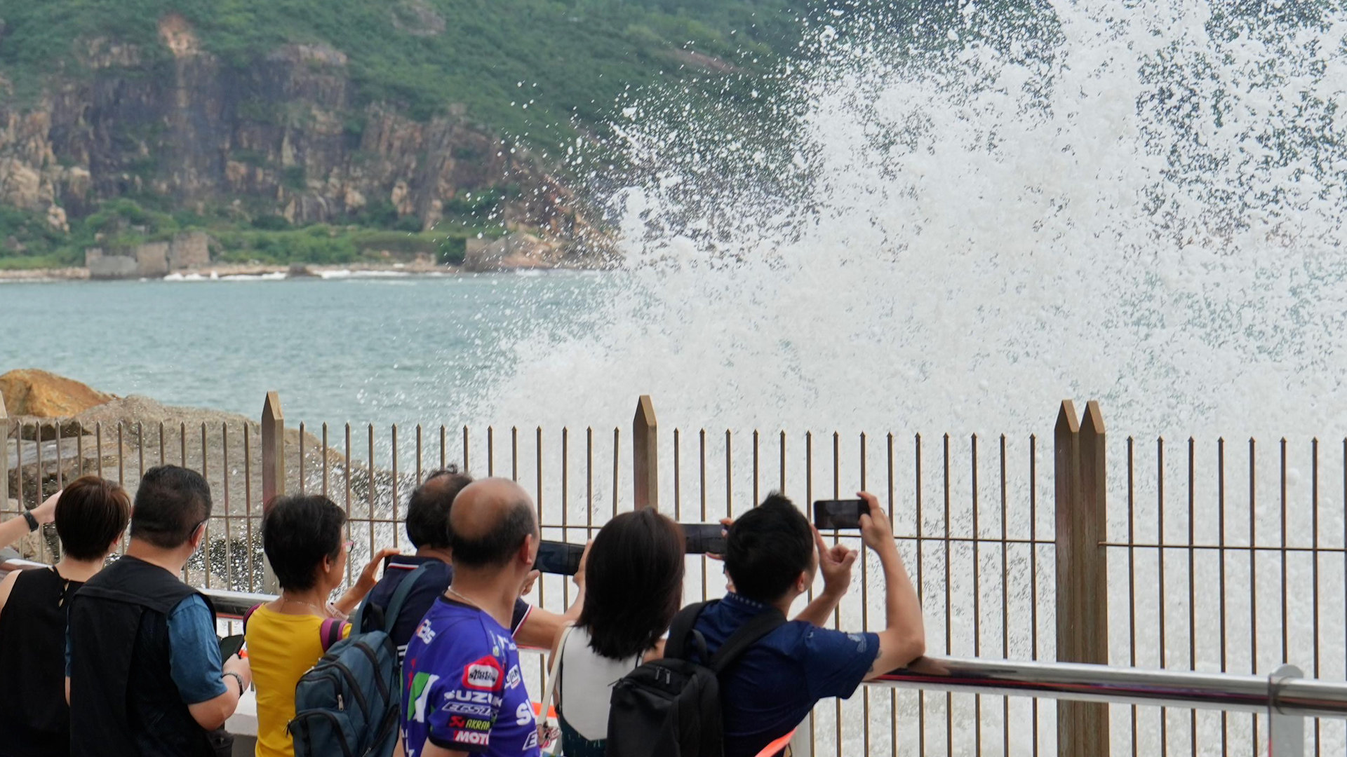 People watching waves as Super Typhoon Ragasa approaches in Heng Fa Chuen