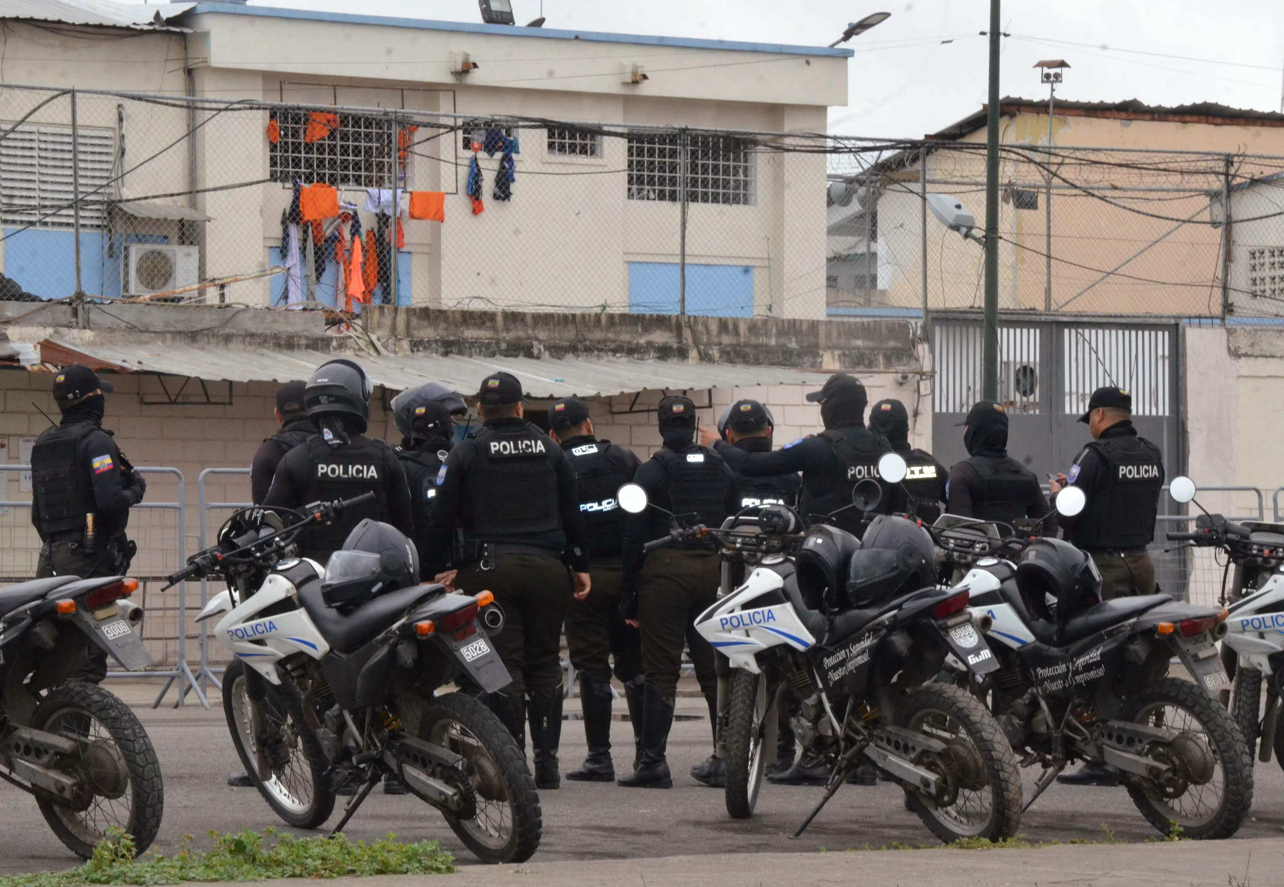 Police officers stand guard outside the main prison in Machala, Ecuador on Monday. Photo: AFP