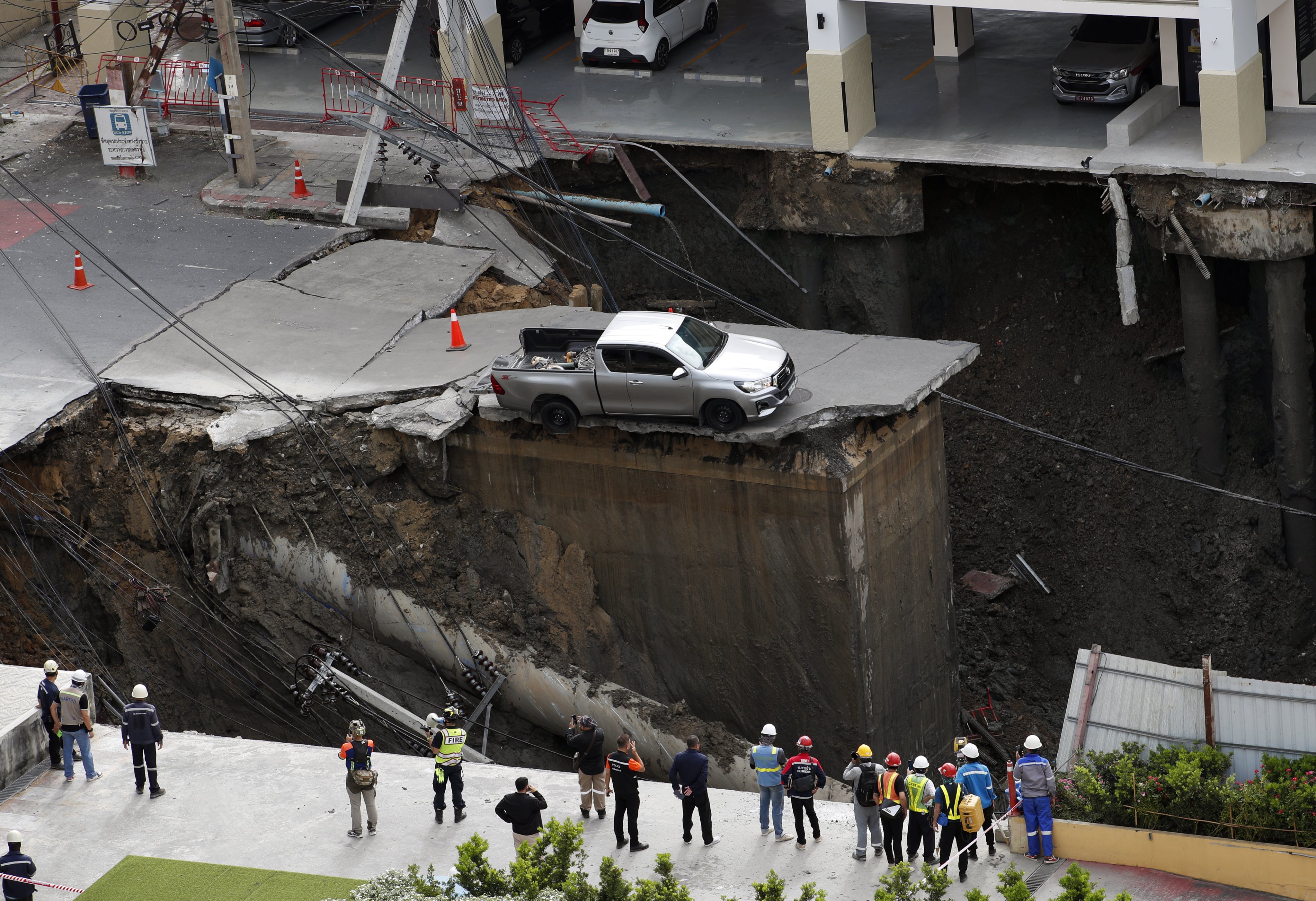 Thai officials inspect a sinkhole in Bangkok on Wednesday. Photo: EPA