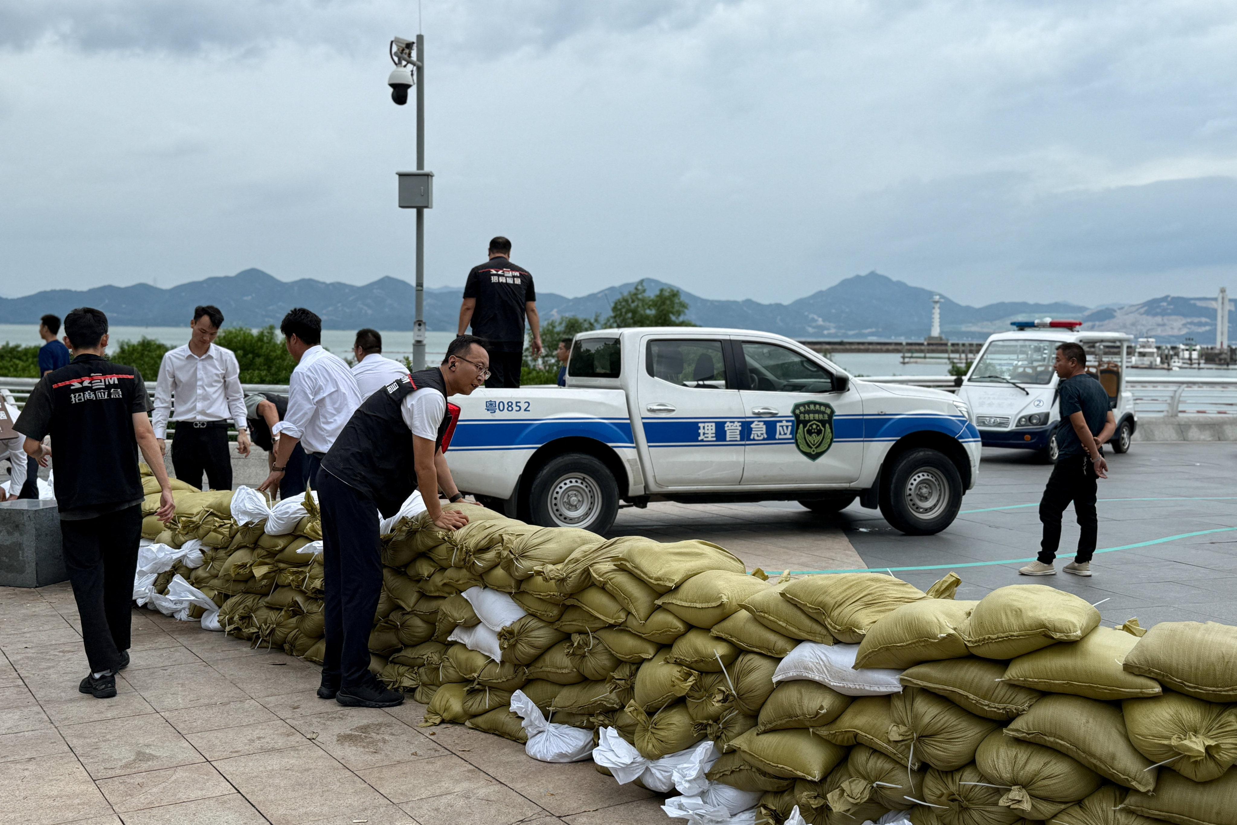 Emergency team members place sandbags at the Shekou waterfront in Shenzhen on Tuesday as Super Typhoon Ragasa approaches. Photo: Reuters