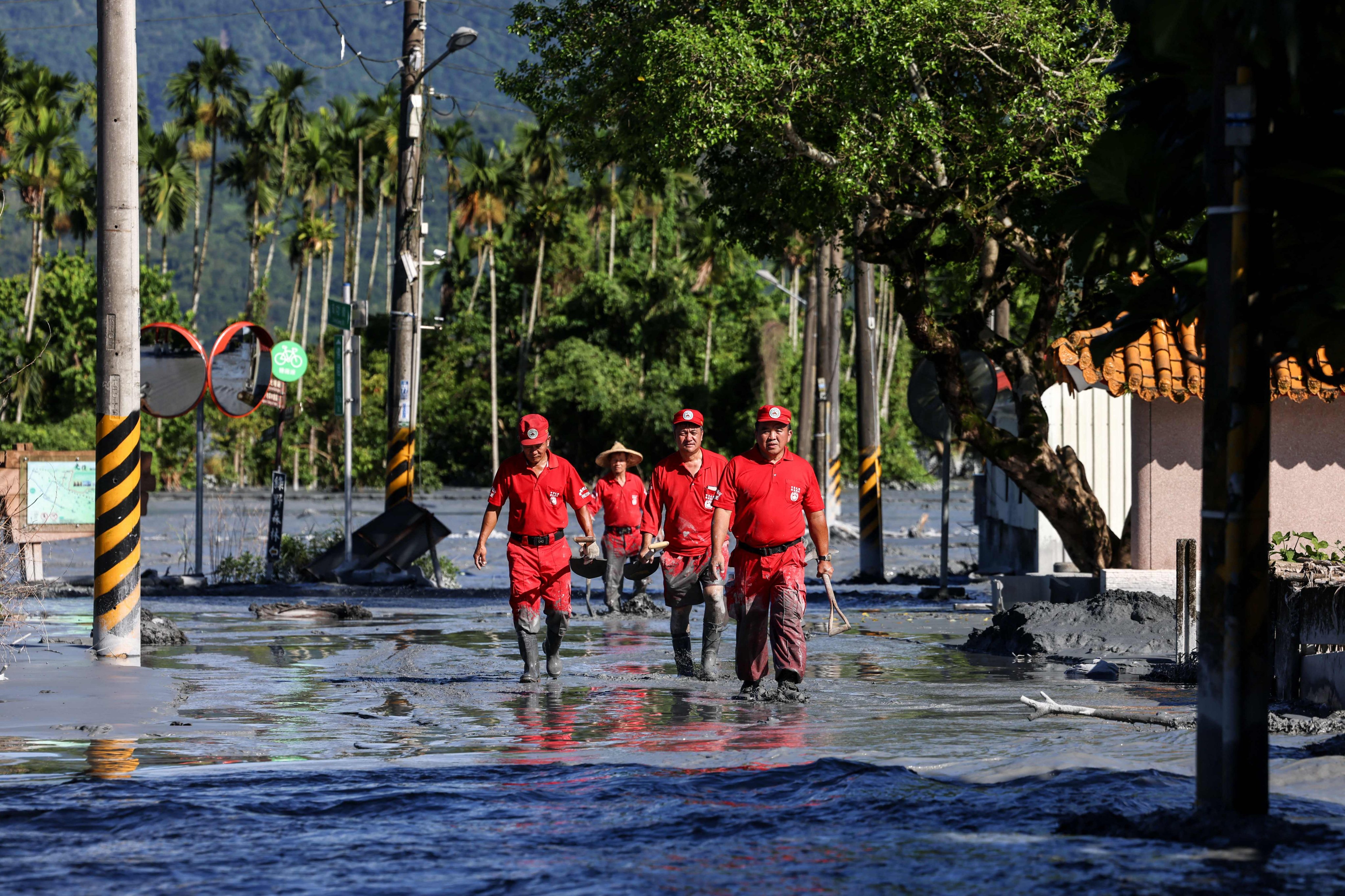 A rescue team looks for flood victims in Hualien on Thursday following torrential rain. The disaster has sparked political hostilities and accusations that fatalities could have been avoided. Photo: AFP