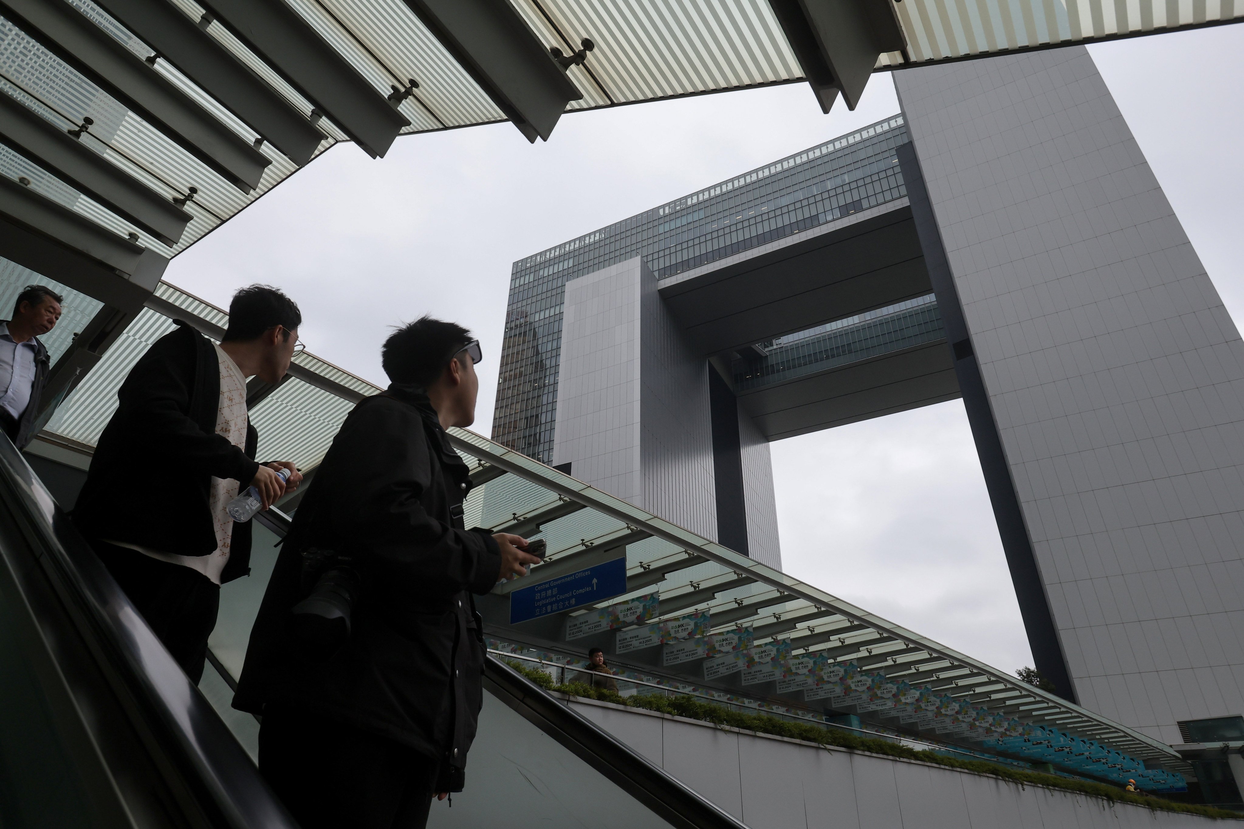 People on an escalator look up at the government headquarters in Tamar, Admiralty, on February 22. Photo: Edmond So