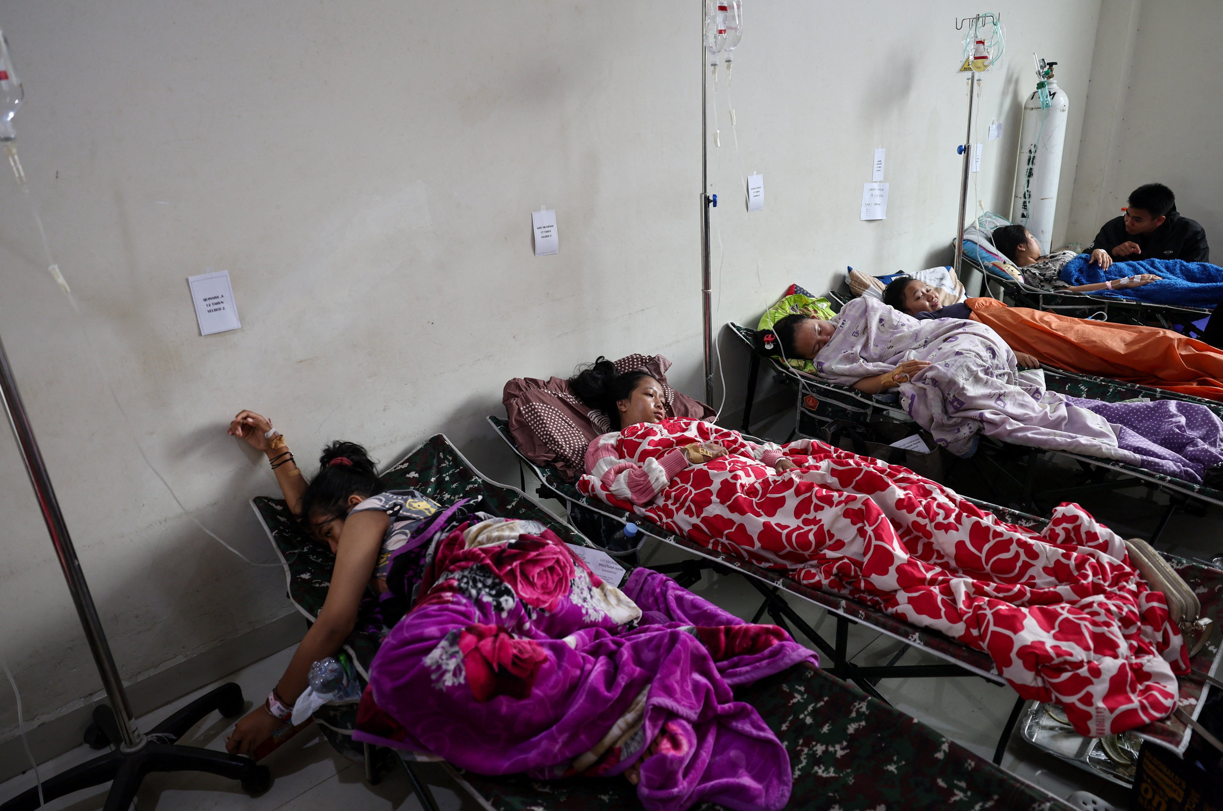Students rest while receiving treatments for food poisoning after eating government-sponsored free school meals, at a hospital in Bandung, West Java, Indonesia, on Thursday. Photo: Reuters