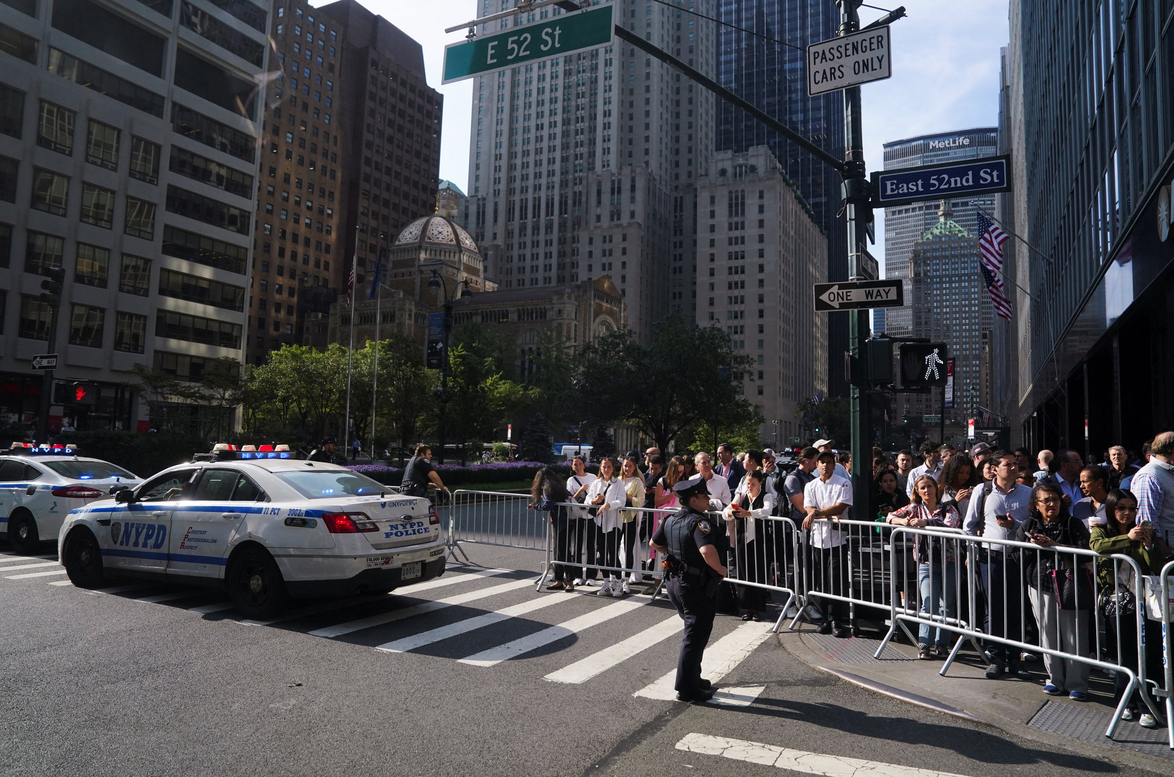 Pedestrians wait as the presidential motorcade of US President Donald Trump drives by during the 80th United Nations General Assembly in New York City on Tuesday. Photo: Reuters