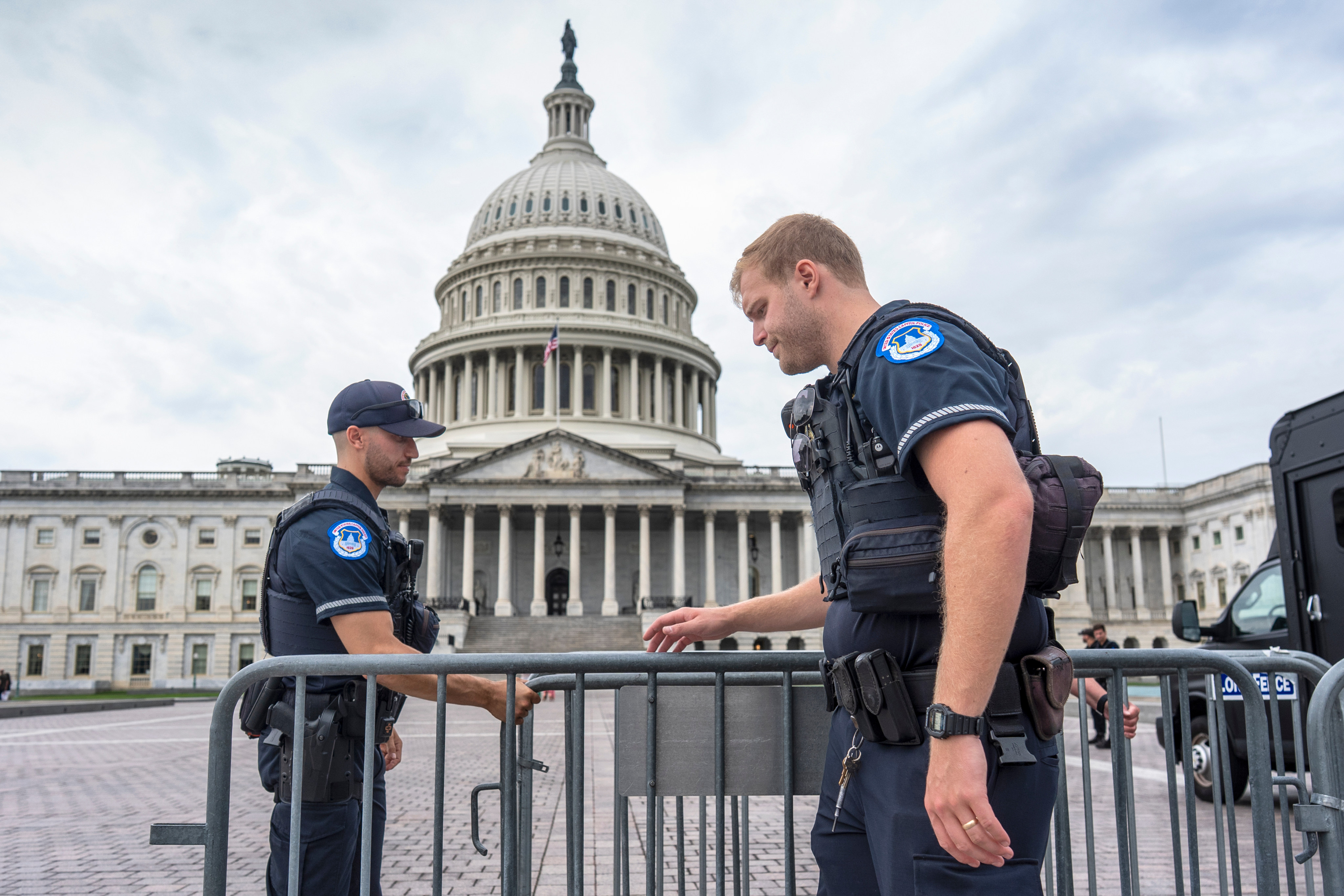 Capitol Police officers adjust security barriers around the East Plaza on Wednesday. Photo: AP
