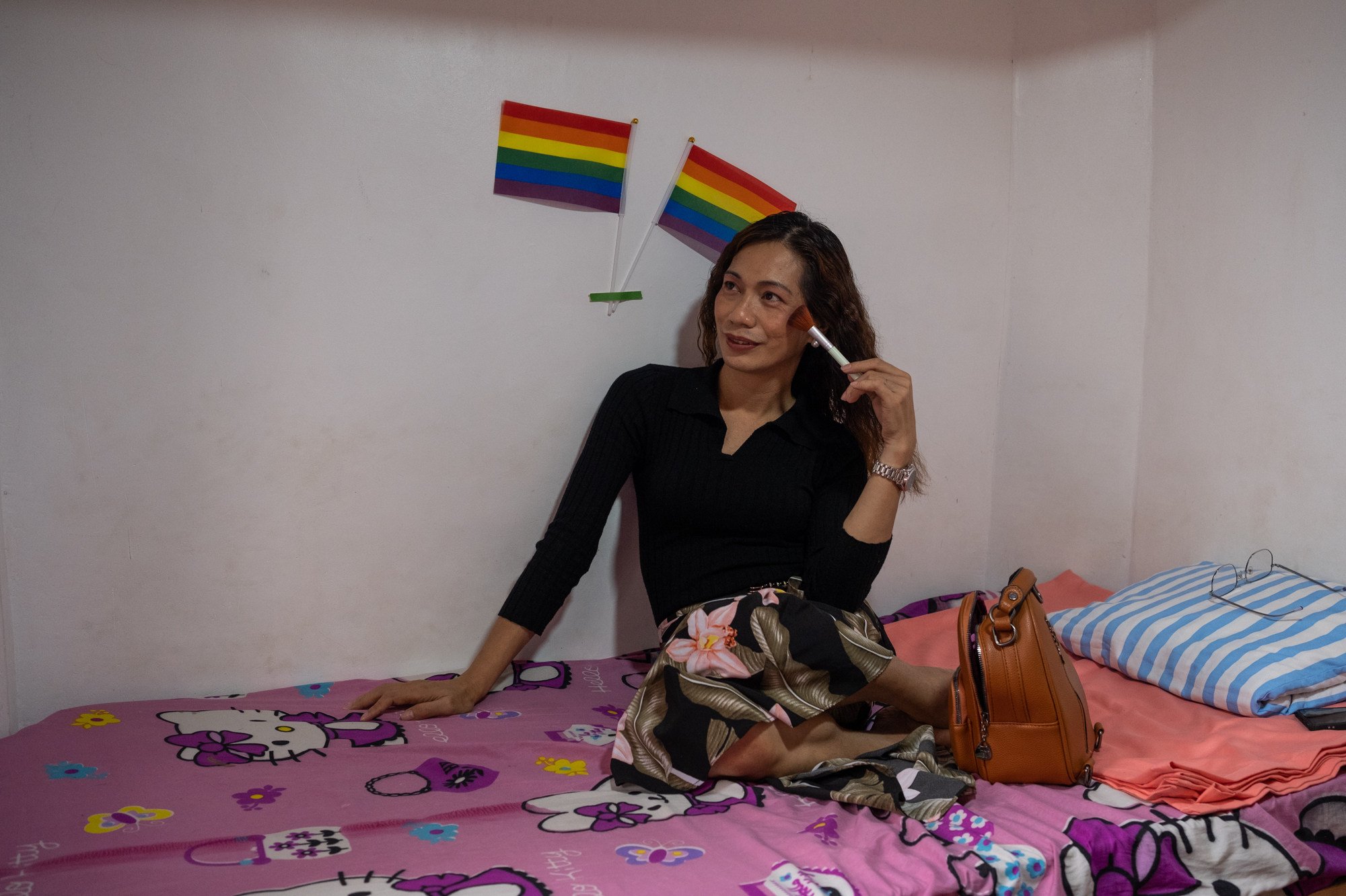 Trans woman Queen Sweetie Acidre puts on makeup inside her home in Quezon City, before her appointment at Klinika Eastwood. Photo: Geela Garcia