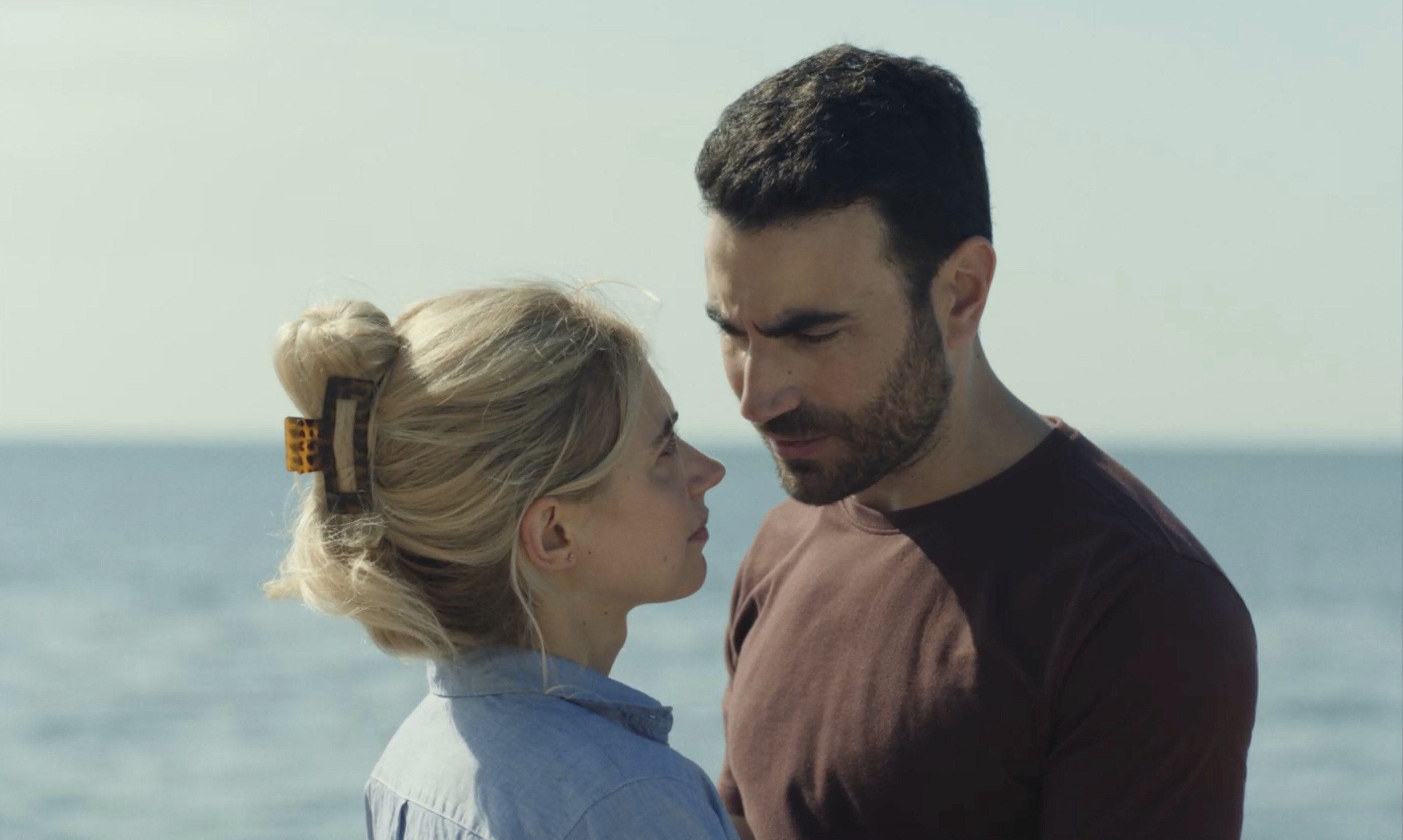 This image released by Apple TV+ shows Brett Goldstein, right, and Imogen Poots in a scene from “All of You.” (Tereza Cervenova/Apple TV+ via AP)