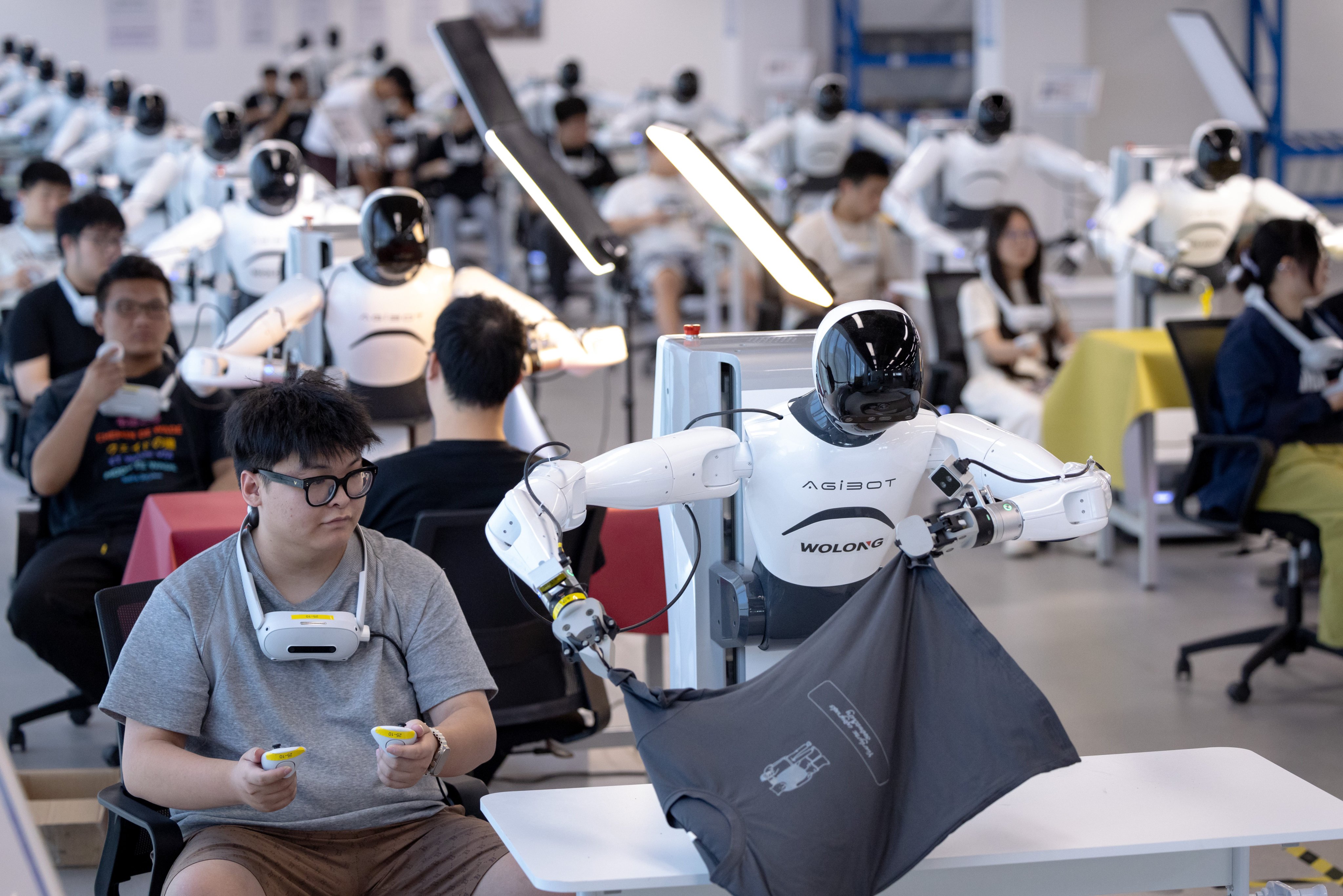 Technicians train humanoid robots at an innovation centre in China’s eastern Zhejiang province. Cities across China are building robot training bases to help local robotics companies accelerate their product development. Photo: Getty Images