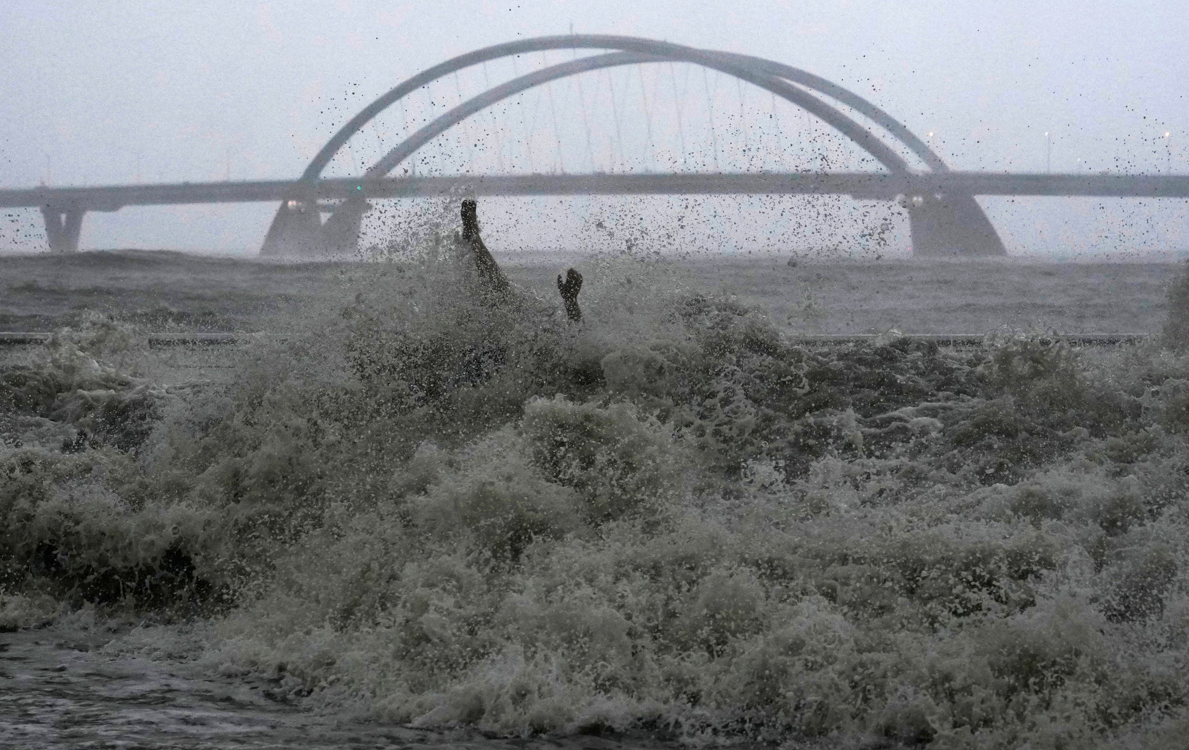 A man sitting on a bench at Tseung Kwan O Promenade was hit by swells during Super Typhoon Ragasa in Hong Kong on September 24. Photo: Elson Li