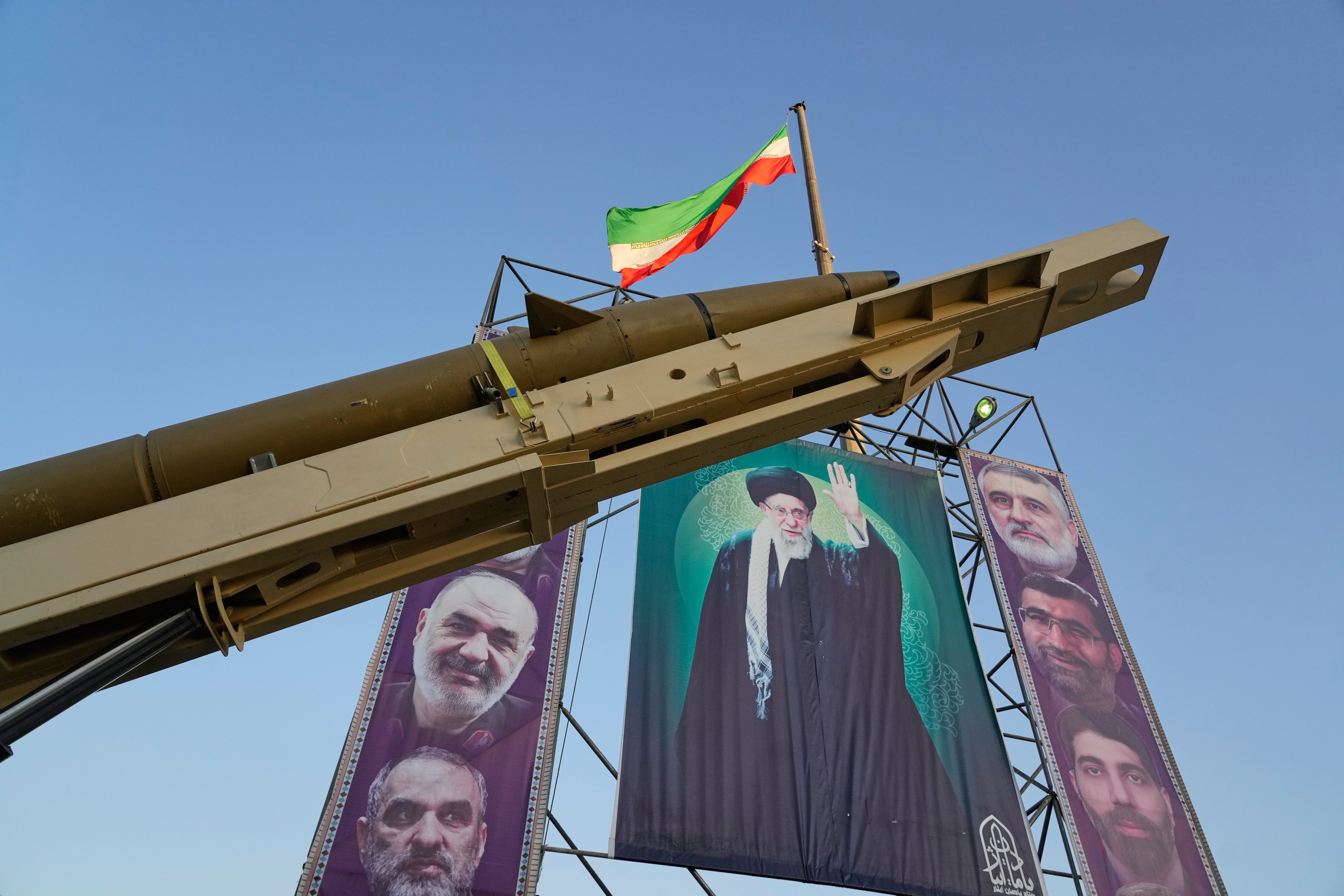 A domestically built missile, called the “Khaibar-buster”, and banners showing portraits of Iranian Supreme Leader Ayatollah Ali Khamenei (centre) are displayed in Tehran on Thursday. Photo: AP