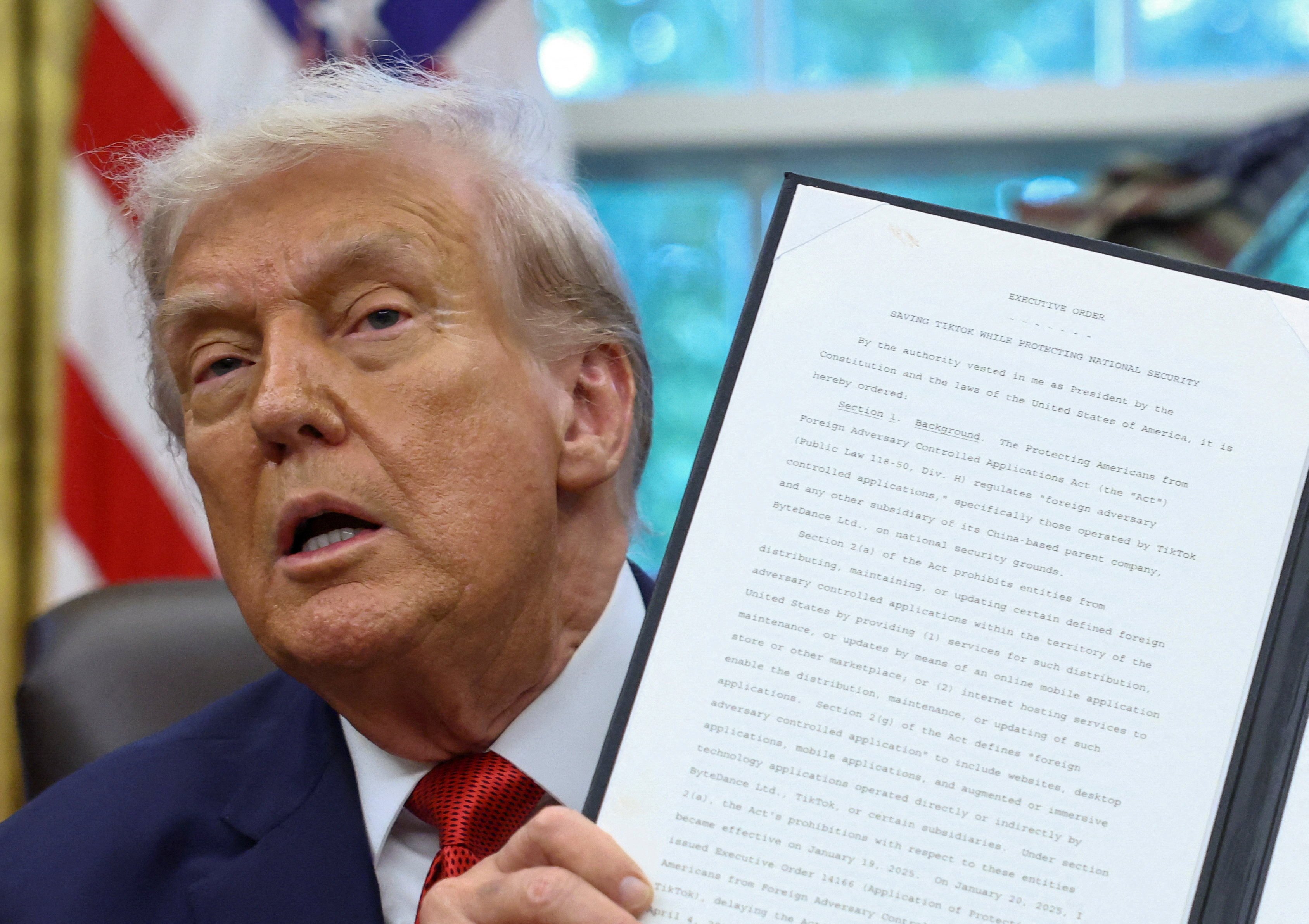 US President Donald Trump shows a signed executive order on a deal that would divest TikTok’s US operations from its Chinese owner ByteDance, at the White House in Washington on September 25. Photo: Reuters