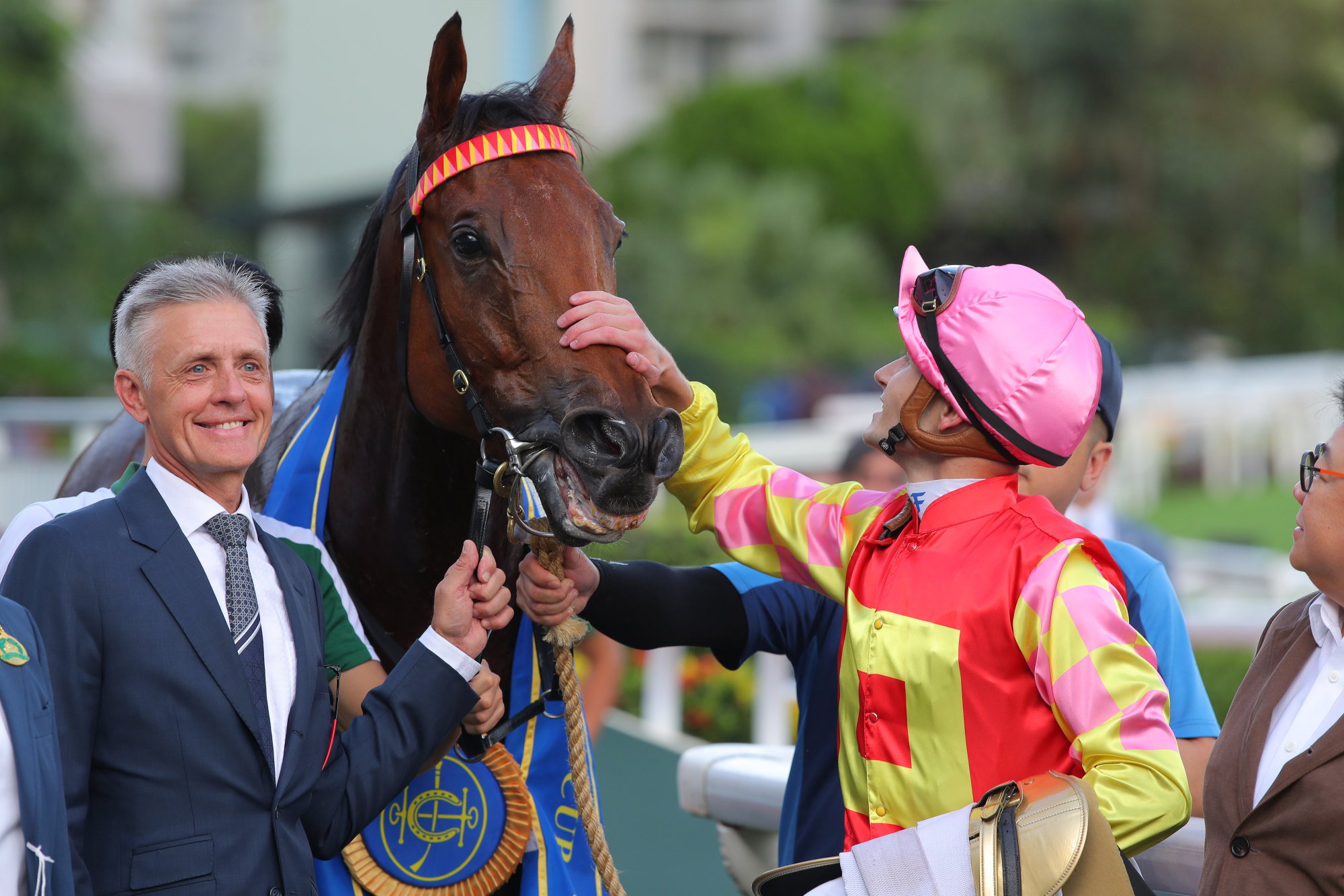 Jockey Luke Ferraris gives My Wish a pat as trainer Mark Newnham smiles for the cameras.