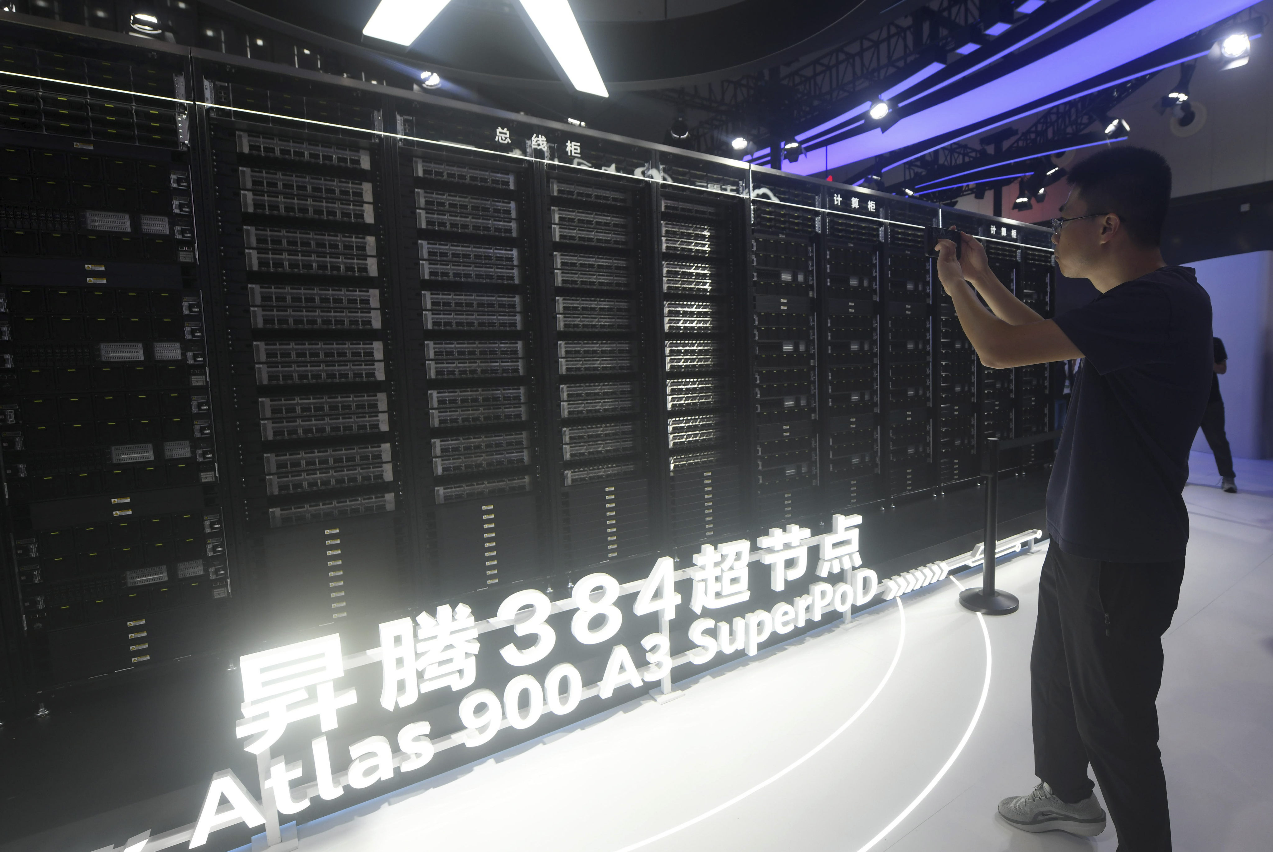 A visitor takes photos of the Huawei Atlas 900 A3 SuperPoD, a computing cluster system, at the World Artificial Intelligence Conference in Shanghai on July 26. Photo: AP