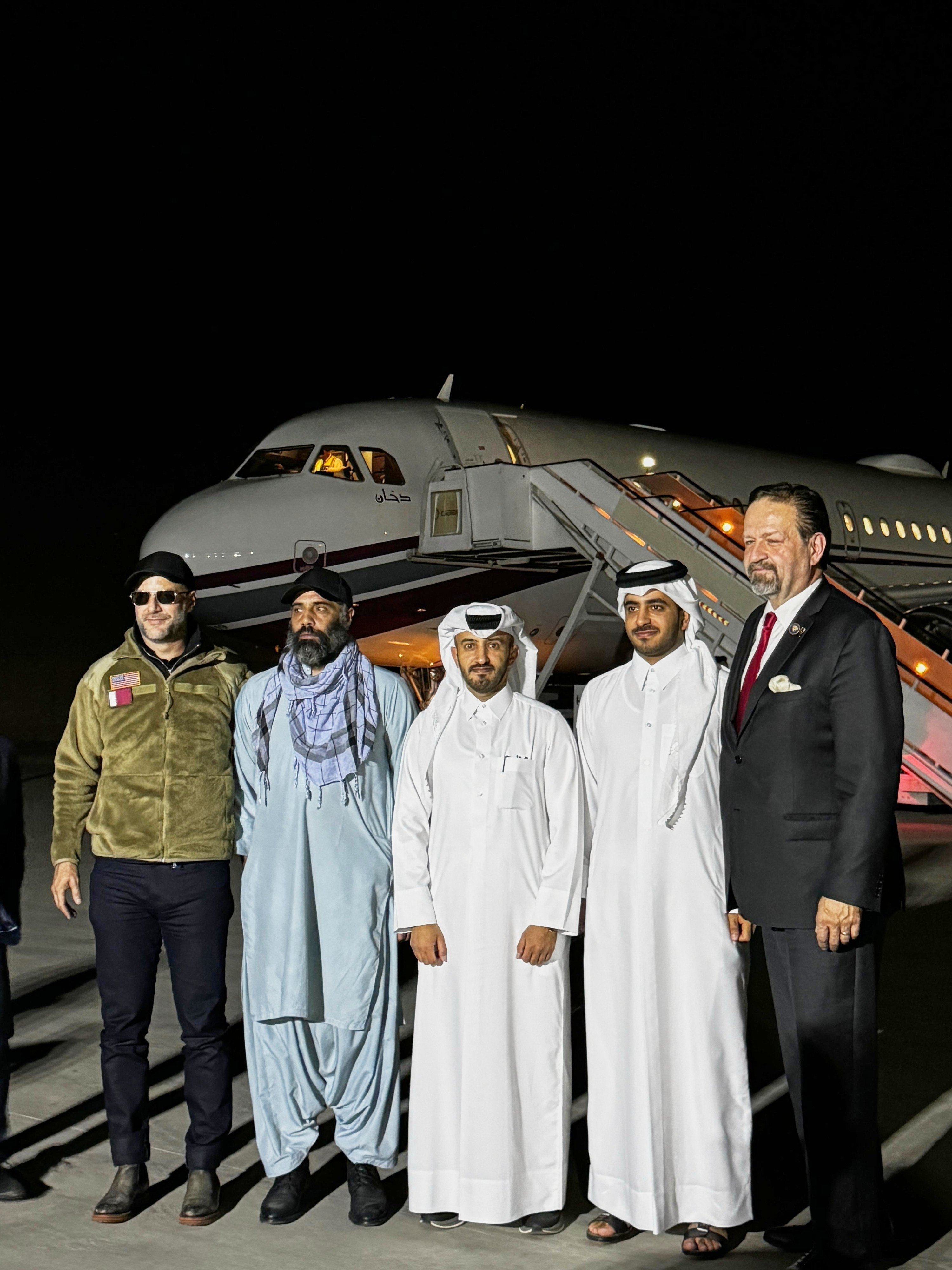 US citizen Amir Amiri, second from left, poses before boarding a plane in Kabul, Afghanistan, on Sunday after being released from an Afghan prison. With him, from right, is Deputy Assistant to the US President Sebastian Gorka, an unidentified Qatari diplomat, Charge d’Affaires of the Qatari embassy in Afghanistan Dr Mirdef al-Qashouti, centre, and, US Special Envoy for Hostage Response Adam Boehler. Photo: Qatar Foreign Ministry via AP
