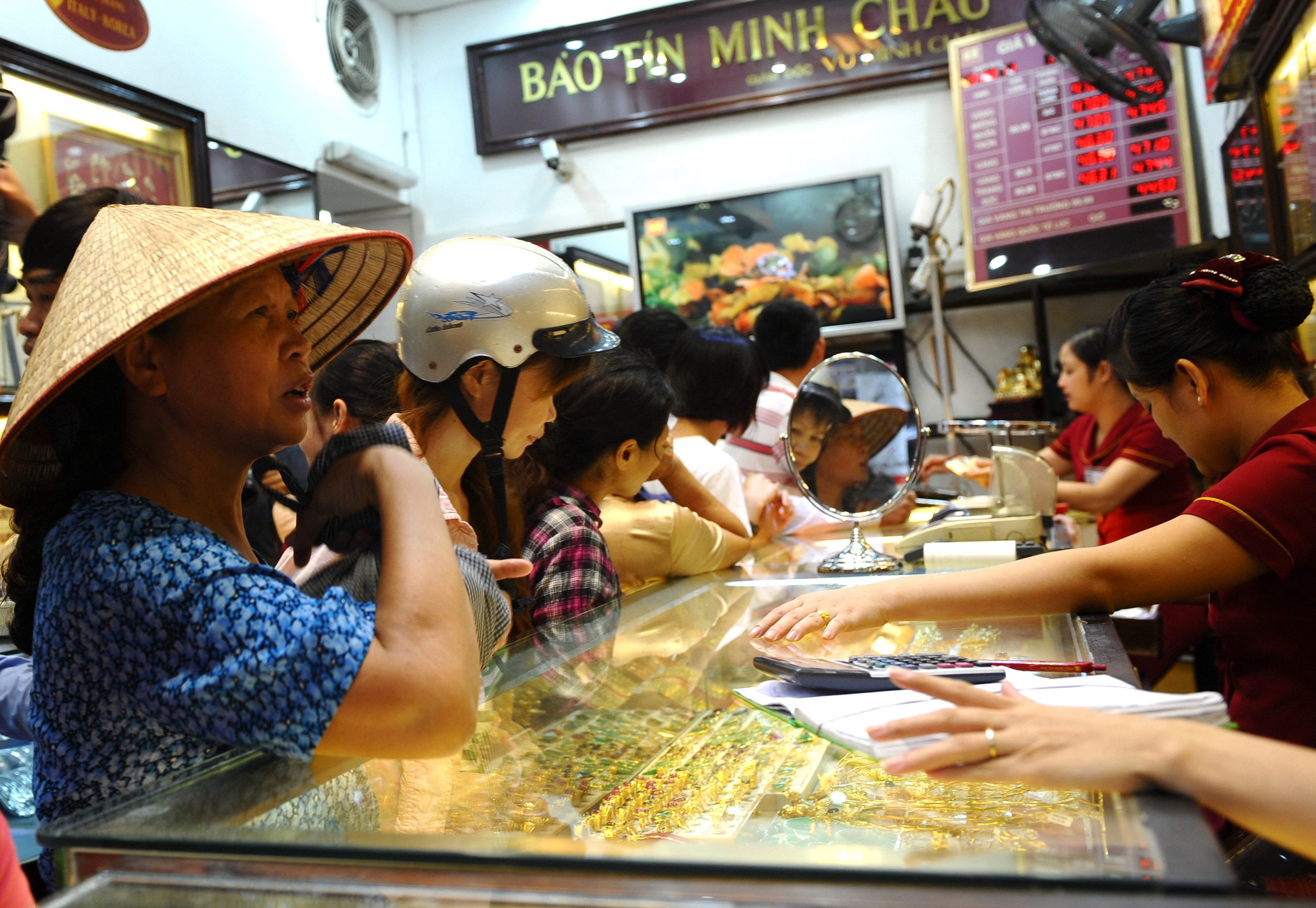 Customers buy and sell gold at a local gold shop in Hanoi. Photo: AFP