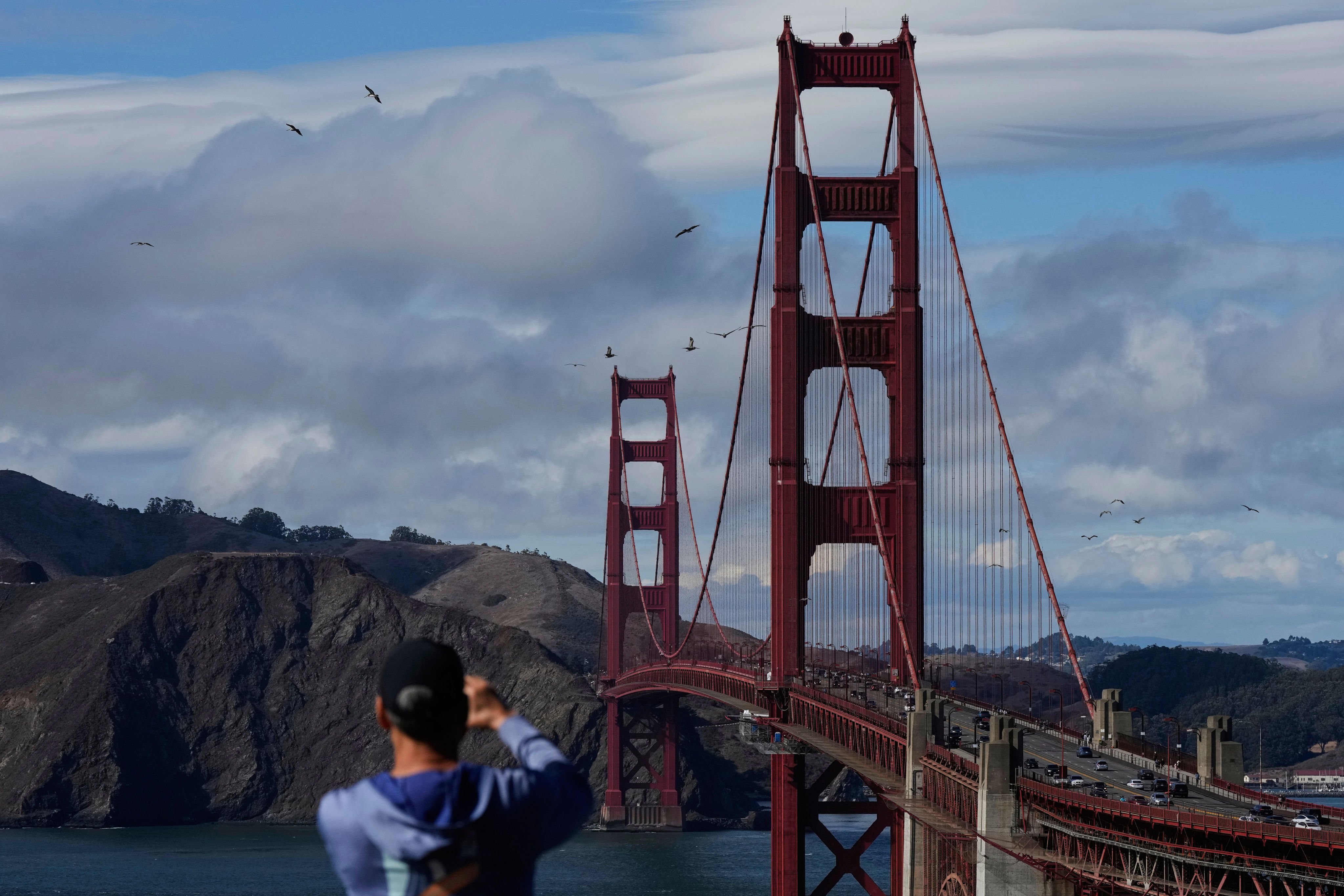 A tourist takes a photograph of the Golden Gate Bridge in San Francisco, California, on September 8. Photo: AP