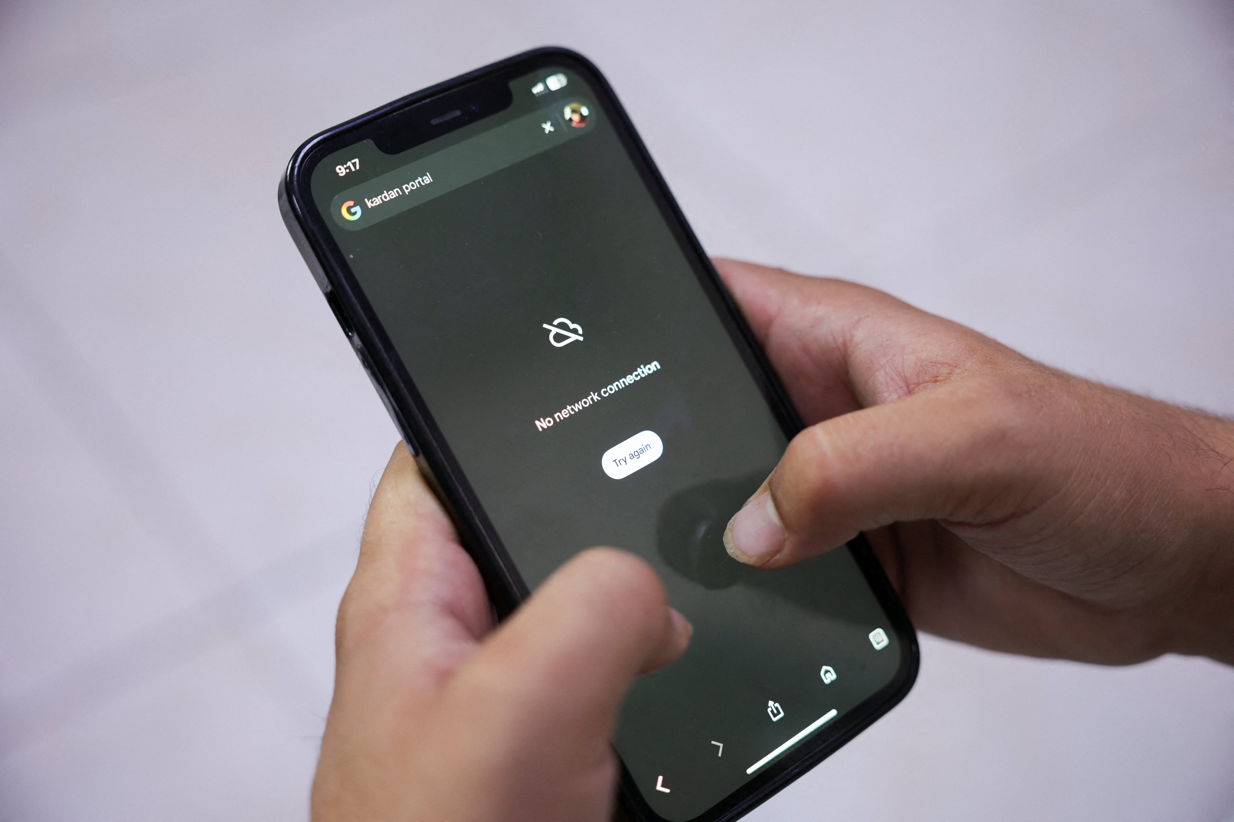 A man tries to use Google on his smartphone amid a total telecom shutdown across Afghanistan on Tuesday. Photo: Reuters