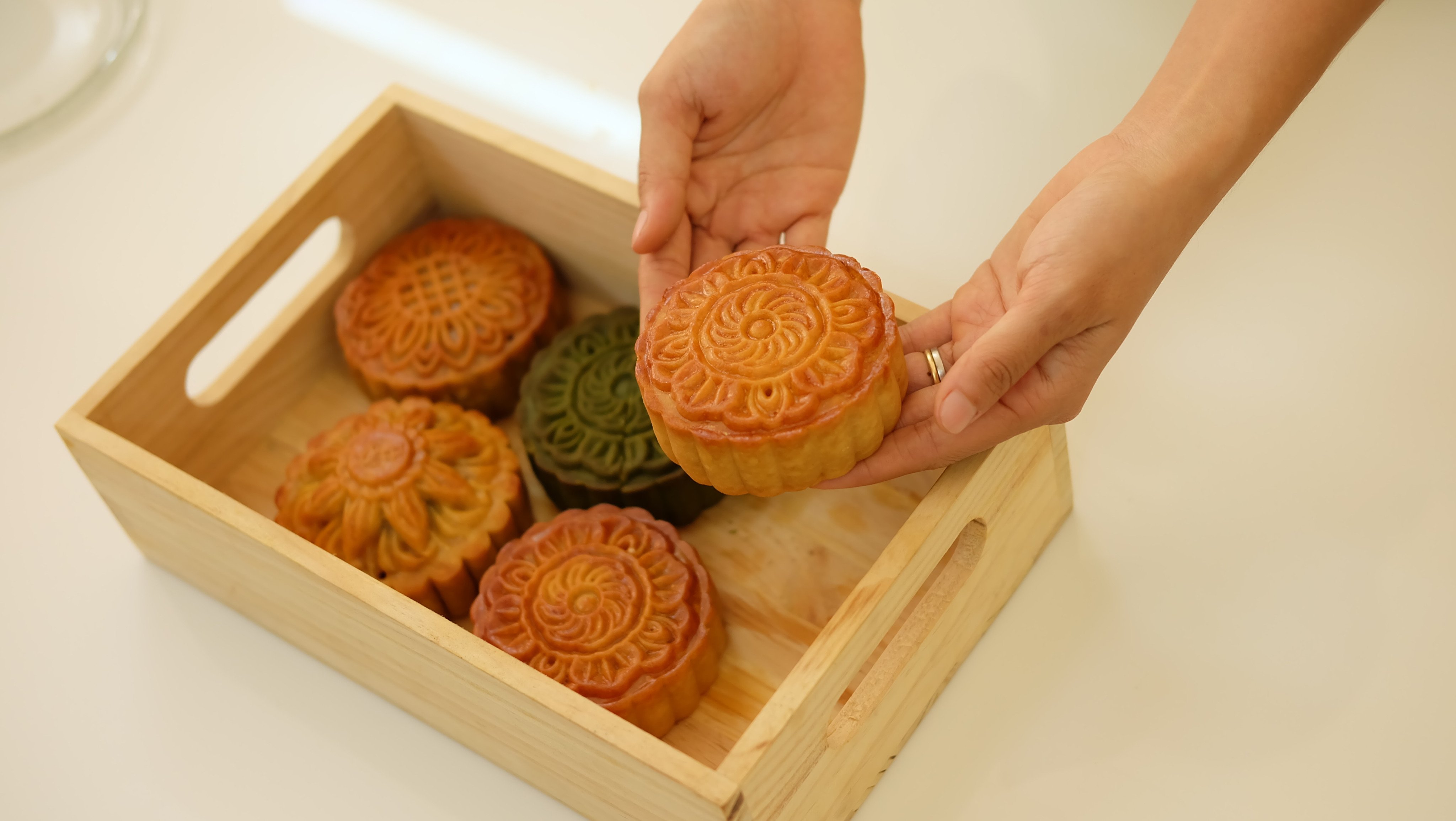 Shutterstock Stock Photo ID: 1484231876 - Hands holding mooncake mid autumn festival