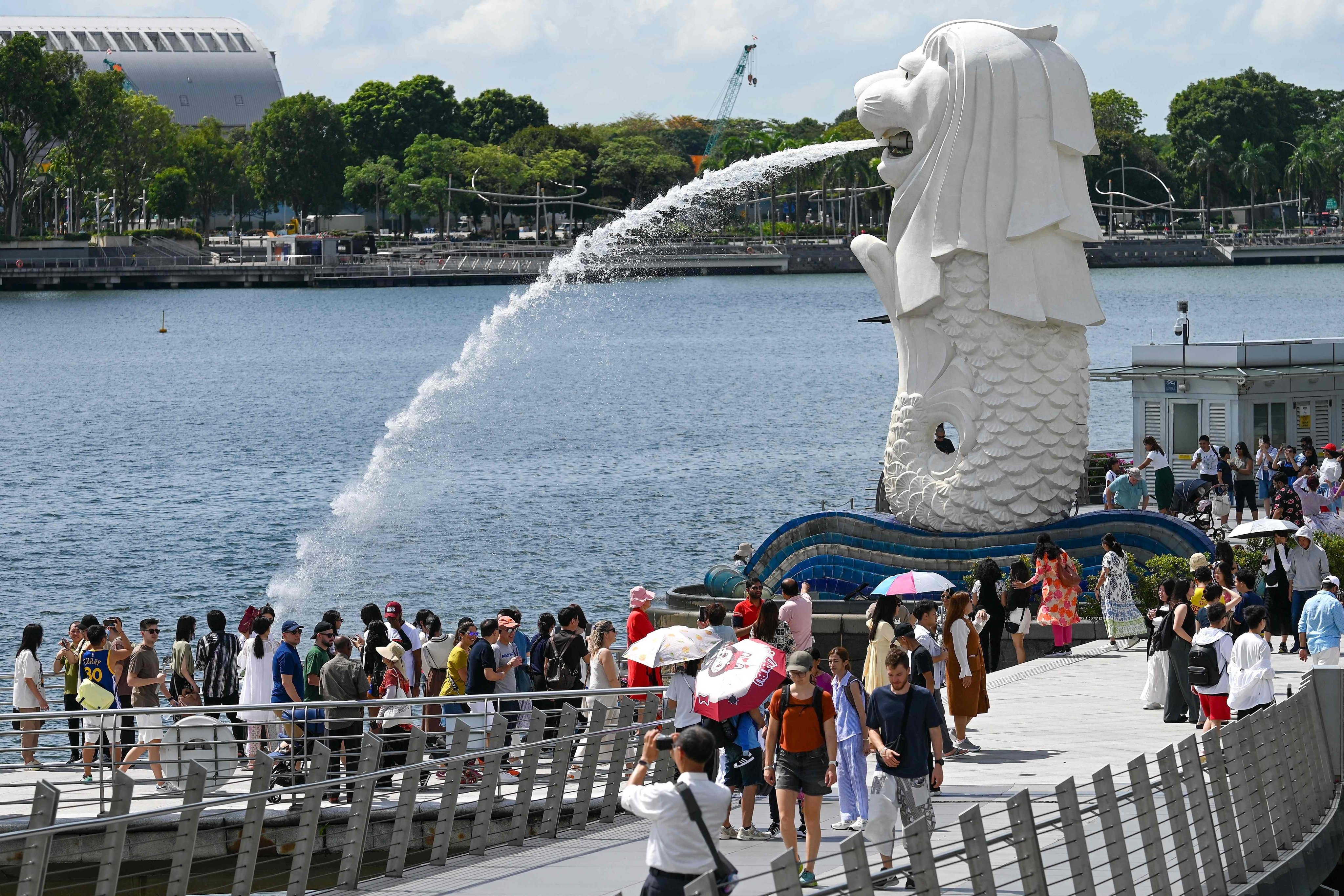 People visit the iconic Merlion statue on the Marina Bay waterfront in Singapore. Photo: AFP