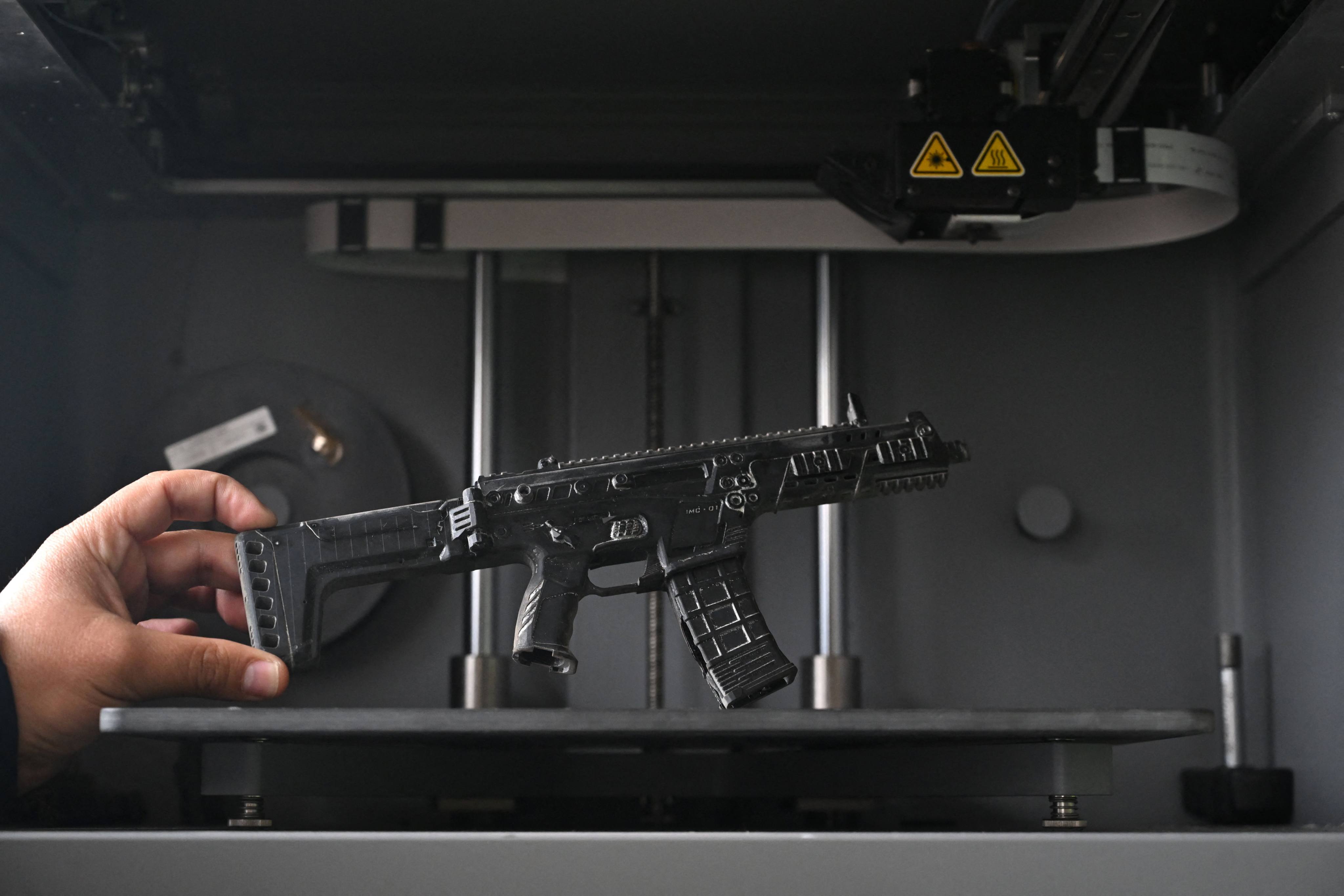 An Indomil engineer shows a prototype of a new rifle designed and manufactured in Colombia. Photo: AFP