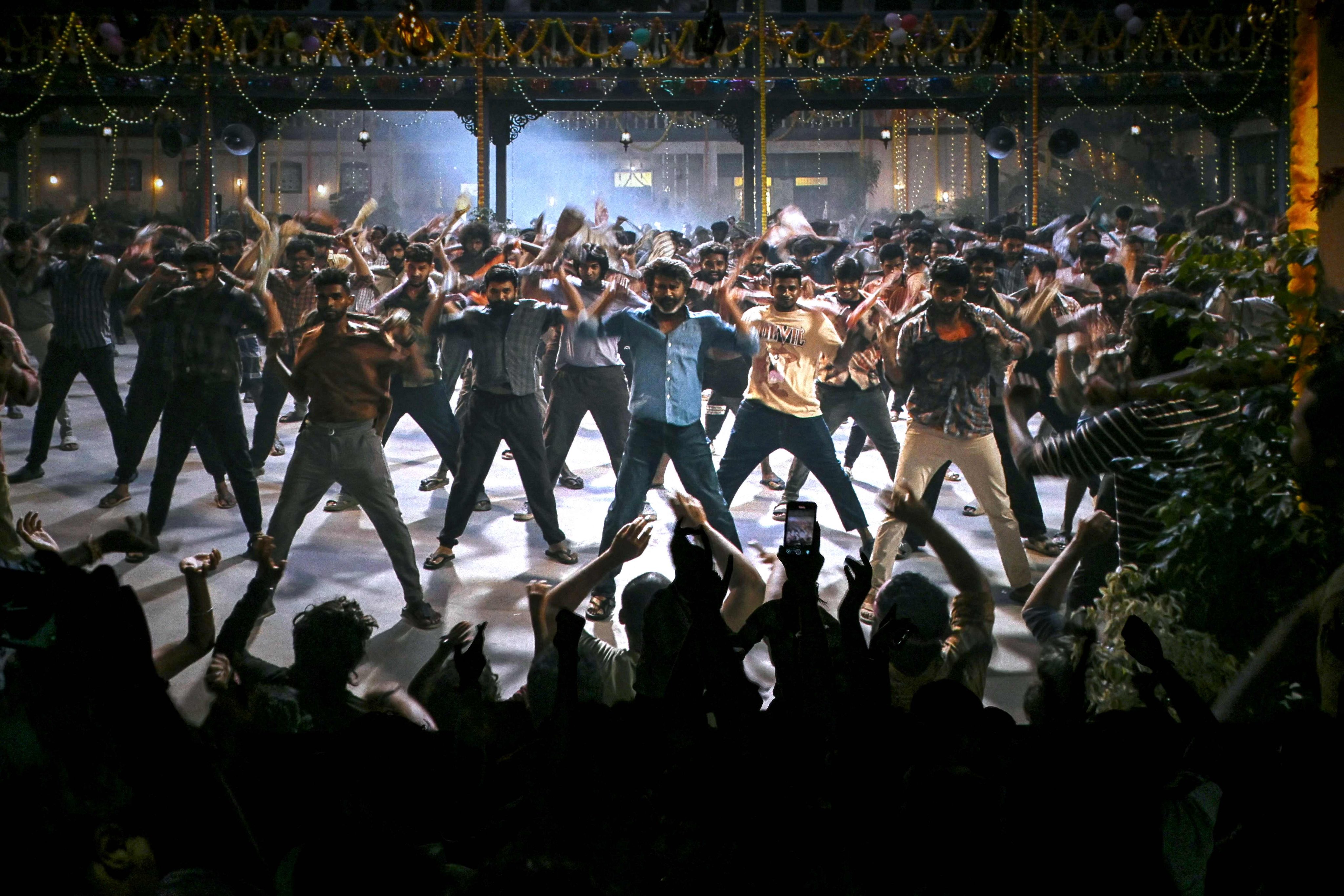 Fans dance inside a cinema during the screening of Indian actor Rajinikanth’s new Tamil-language movie “Coolie” on the first day of its release in Mumbai on August 14. Photo: AFP